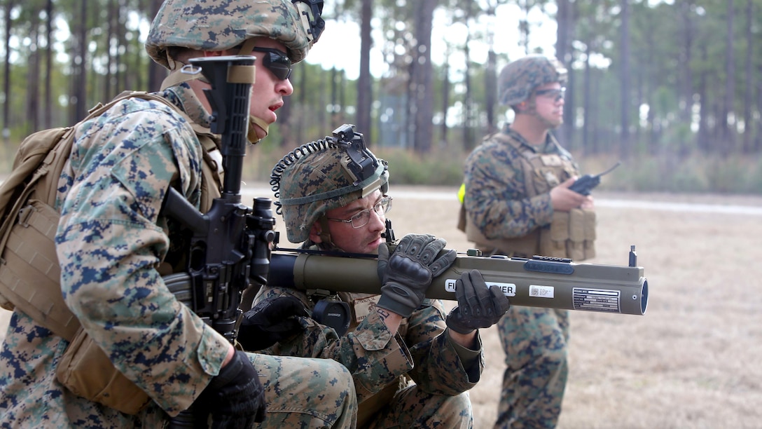 Lance Cpl. Michael G. Battaglia (center) looks down range with Cpl. Jason Salcido (left) after firing an AT4 rocket launcher as part of a live-fire range during a squadathon at Camp Lejeune, N.C., Jan. 12, 2017. The squadathon was an opportunity for squad leaders to improve as leaders and learn to better control their squads. Battaglia is a rifleman and Salcido is a squad leader with 1st Battalion, 8th Marine Regiment, 2nd Marine Division.