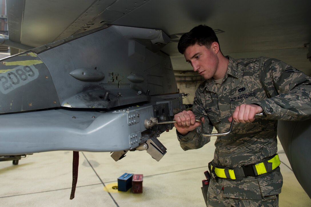 Airman 1st Class John Gaddis, 52nd Aircraft Maintenance Squadron tactical aircraft weapons system specialist, prepares an F-16 Fighting Falcon for inert weapons during the annual weapons load competition in Hangar One at Spangdahlem Air Base, Germany, Jan. 20, 2017. The two competing teams of three Airmen competed for the title of wing’s best load crew. The winning team’s completion time will be compared to other squadrons in the Major Command to determine the best load crew in United States Air Forces in Europe. Wing winners will be announced at the Maintenance Professional of the Year banquet here March 10, 2017. (U.S. Air Force photo by Airman 1st Class Preston Cherry)