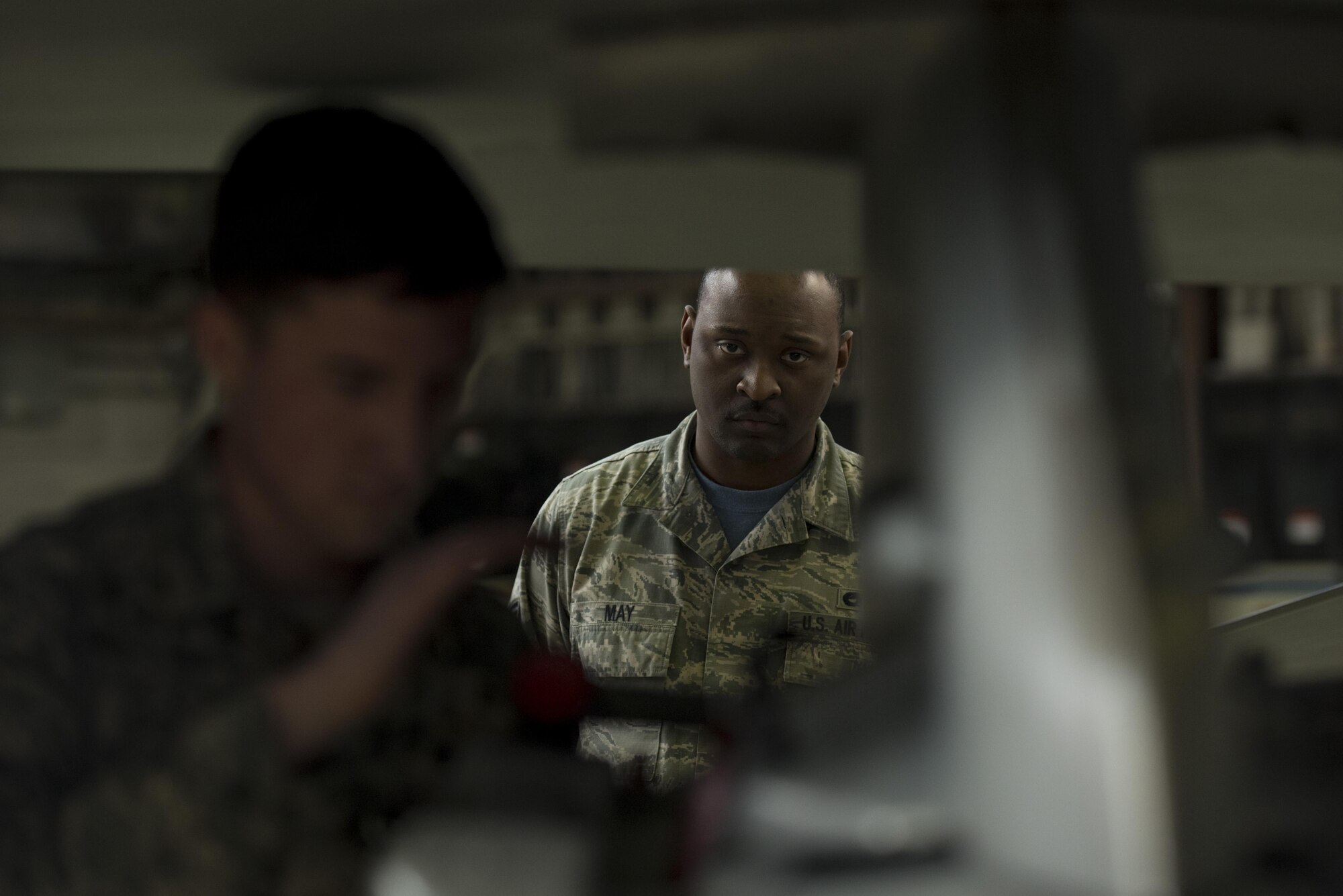 Staff Sgt. Kiefer May, 52nd Maintenance Group squadron lead crew member, center, evaluates Airman 1st Class John Gaddis, 52nd Aircraft Maintenance Squadron tactical aircraft weapons system specialist, left, during the annual weapons load competition in Hangar One at Spangdahlem Air Base, Germany, Jan. 20, 2017. The competition, consisting of two competing teams, was scored for safety and reliability, but speed and technical accuracy played a major role in scoring points to become the wing’s best load crew. Winners will be announced at the Maintenance Professional of the Year banquet here March 10, 2017. (U.S. Air Force photo by Airman 1st Class Preston Cherry)
