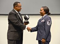 Master Sgt. Miya Moore-Felton, chairman of the Martin Luther King Jr. Celebration event committee, presented Reverend Rodney Payne, the guest speaker at the Celebration, with a token of appreciation on behalf of the committee. (Air Force photo by Kelly White)