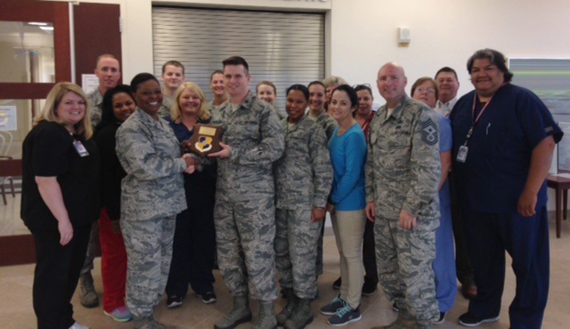 72nd Air Base Wing Commander Col. Stephanie Wilson presents a Wildcatter Award to Dr. Major William Hinojosa and the 72nd ABW Surgical Services Flight. The Flight members pictured are, from left, Alison Headrick, Leilani Lawrence, Senior Airman Ethan Carter, Christina Wilson, Senior Airman Jason Eldridge, Tech. Sgt. Amanda Keel, Doctor Maj. William Hinojosa, Doctor Capt. Lindsey July, Tech. Sgt. Olomide McKoy-Quinones, Senior Airman Samantha Johnson, Kelley Jaques, Lynn Rookard, Ramonda Rogers, 72nd ABW Command Chief Master Sgt. David Tuck, Lisa Upton, Dr. William Mead and Luis Negron. (Courtesy photo)