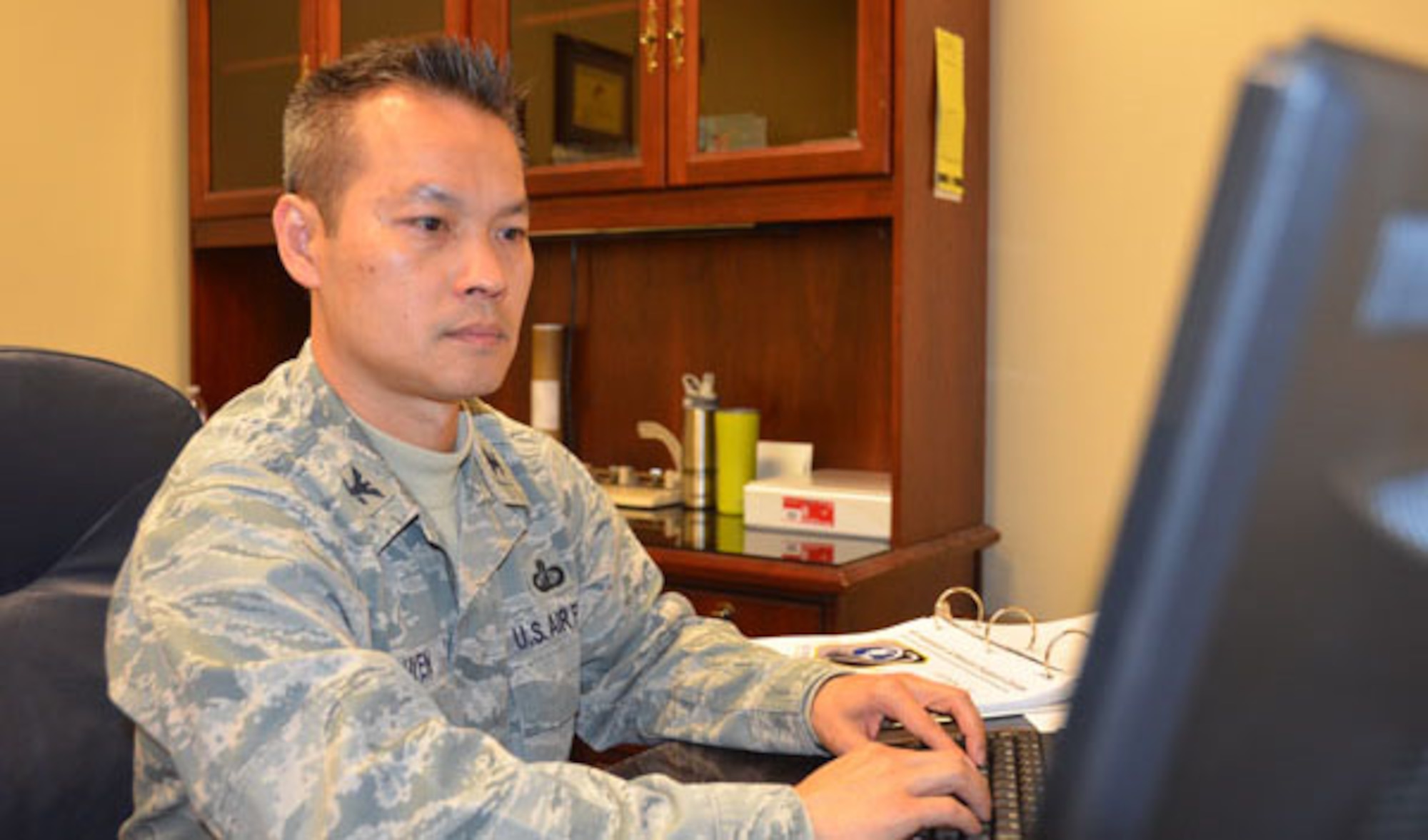 Col. Quy Nguyen's ability to focus on the task at hand and stay positive impresses Maj. Edith Coon, AFIMSC chief of financial operations and integration. "He's very good at balancing family and work," Coon said. (U.S. Air Force photo/James Truitt)