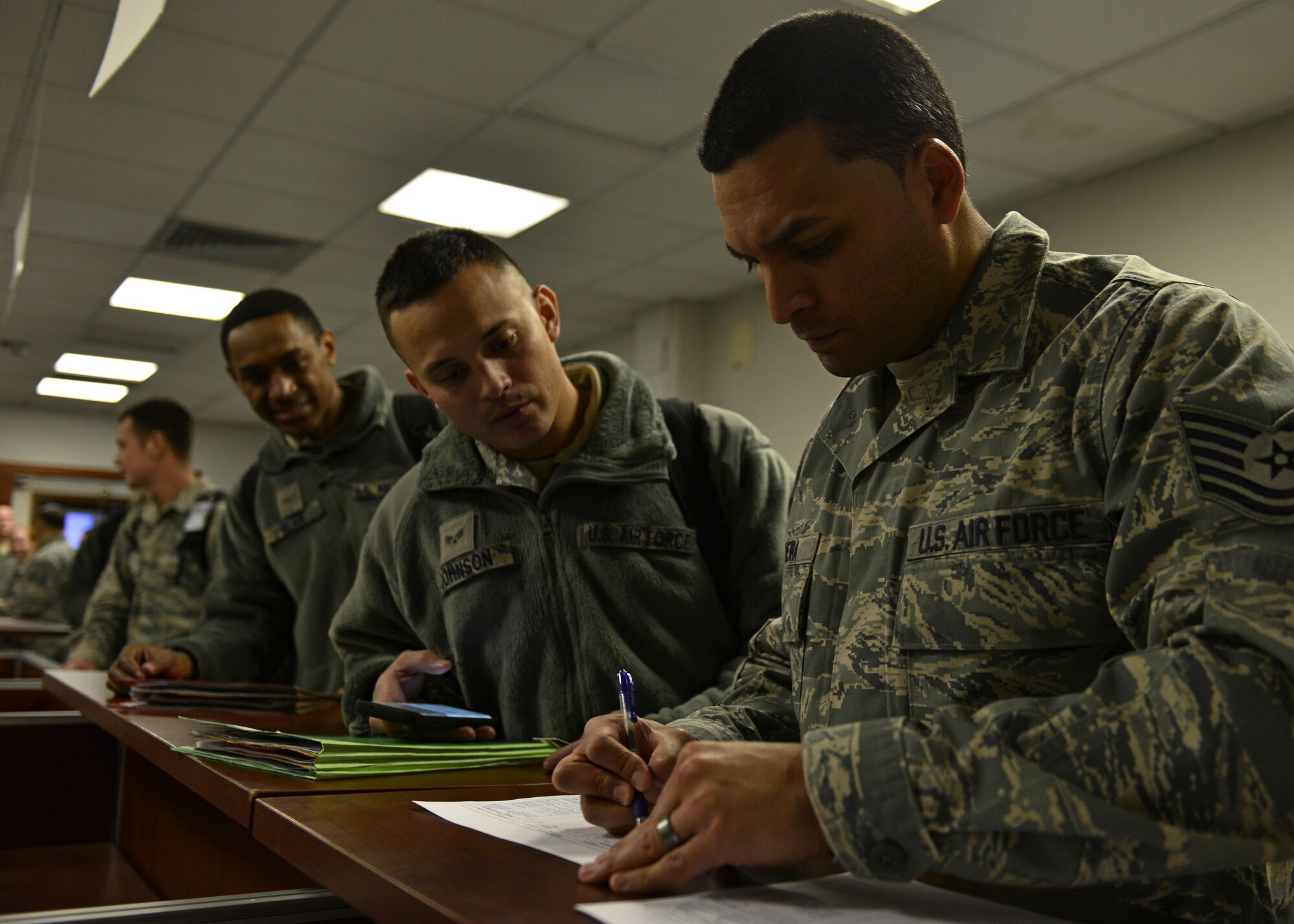 Airmen from the 31st Fighter Wing process through the personnel deployment function line at Aviano Air Base, Italy on Jan. 21, 2017. The Airmen traveled to Souda Bay, Greece, to support a flying training deployment with the Hellenic air force. (U.S. Air Force photo by Senior Airman Cary Smith)