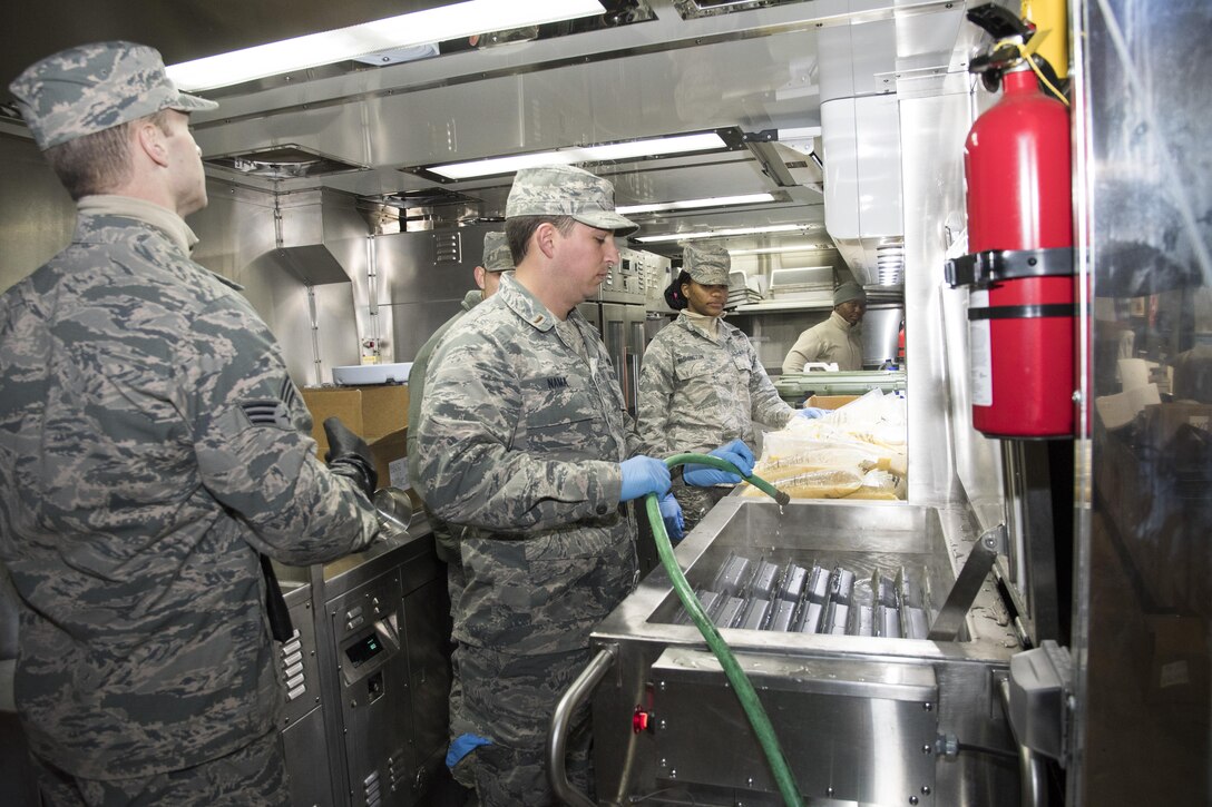 U.S. Airmen from the 116th Air Control Wing (ACW) Services Flight, Georgia Air National Guard (ANG), prepare dinner for joint-forces personnel supporting the 58th Presidential Inauguration, Washington, D.C., January 19, 2017. A team of 10 Airmen from the 116th ACW deployed with their Disaster Relief Mobile Kitchen Trailer, or DRMKT.  Working from FedEx Field, home to the Washington Redskins, the team worked along side services teams from other ANG units across the nation preparing and serving meals to about 3,500 joint-force members per day deployed to the National Capital Region. In all, about 7,500 National Guard Soldiers and Airmen, from 44 states, three territories and the District of Columbia, served with the specially created Joint Task Force – District of Columbia. As a whole, National Guard Soldiers and Airmen augmented the U.S. Secret Service, U.S. Capitol Police and D.C. Metropolitan Police forces on a range of support including traffic control, crowd management, logistics and communication. (U.S. Air National Guard photo by Senior Master Sgt. Roger Parsons)