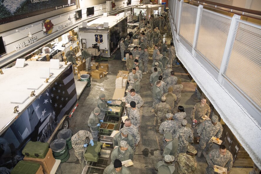 U.S. Airmen from the 116th Air Control Wing (ACW) Services Flight, Georgia Air National Guard (ANG), along with other ANG Services Units from across the nation, serve breakfast to joint-forces personnel supporting the 58th Presidential Inauguration, Washington, D.C., January 19, 2017. A team of 10 Airmen from the 116th ACW deployed with their Disaster Relief Mobile Kitchen Trailer, or DRMKT.  Working from FedEx Field, home to the Washington Redskins, the team worked along side services teams from other ANG units across the nation preparing and serving meals to about 3,500 joint-force members per day deployed to the National Capital Region. In all, about 7,500 National Guard Soldiers and Airmen, from 44 states, three territories and the District of Columbia, served with the specially created Joint Task Force – District of Columbia. As a whole, National Guard Soldiers and Airmen augmented the U.S. Secret Service, U.S. Capitol Police and D.C. Metropolitan Police forces on a range of support including traffic control, crowd management, logistics and communication. (U.S. Air National Guard photo by Senior Master Sgt. Roger Parsons)