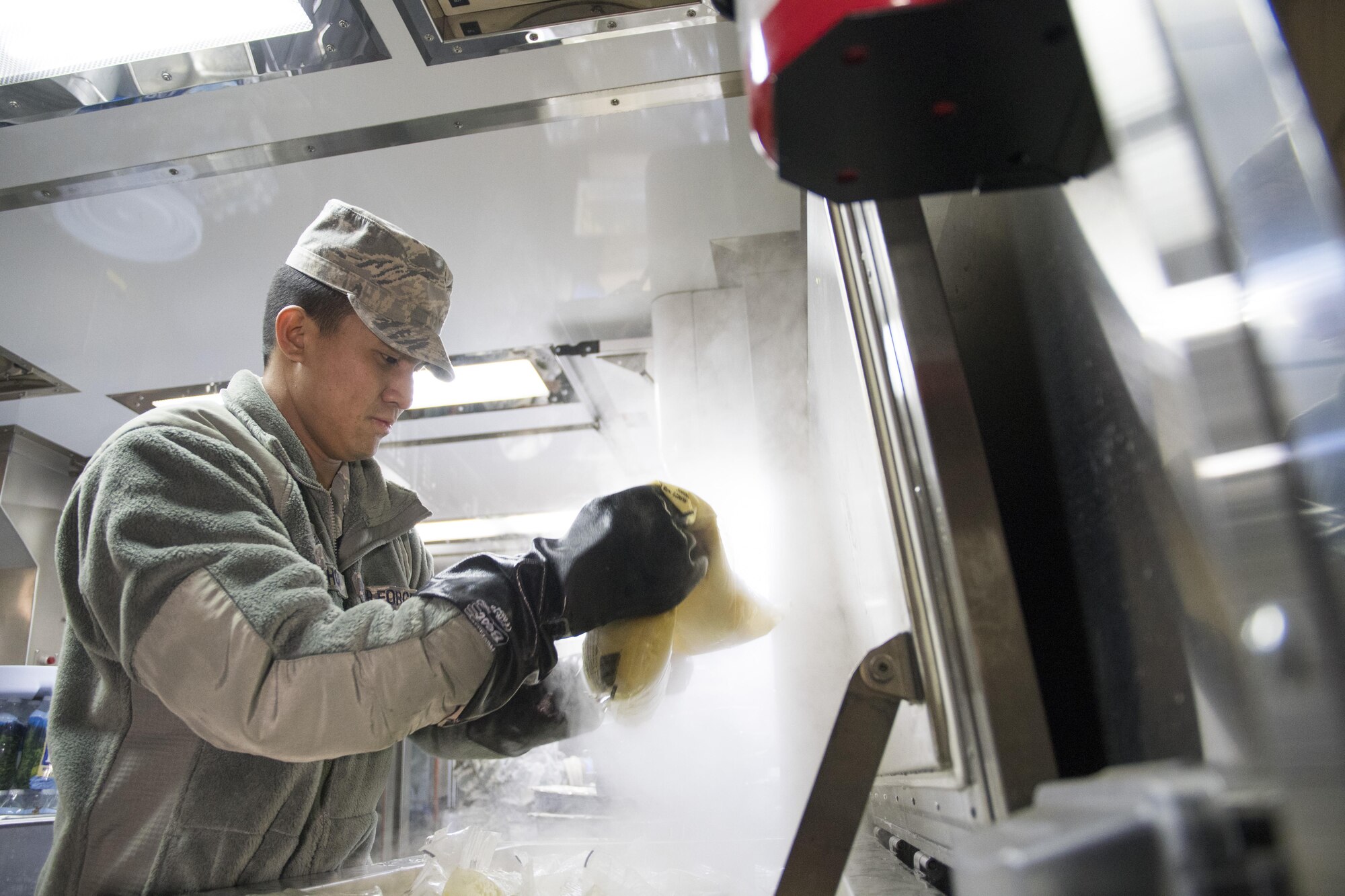 U.S. Air Force Staff Sgt. Daniel McMahon from the 116th Air Control Wing (ACW) Services Flight, Georgia Air National Guard (ANG), inspects a package of scrambled eggs while preparing breakfast for joint-forces personnel supporting the 58th Presidential Inauguration, Washington, D.C., January 19, 2017. A team of 10 Airmen from the 116th ACW deployed with their Disaster Relief Mobile Kitchen Trailer, or DRMKT.  Working from FedEx Field, home to the Washington Redskins, the team worked along side services teams from other ANG units across the nation preparing and serving meals to about 3,500 joint-force members per day deployed to the National Capital Region. In all, about 7,500 National Guard Soldiers and Airmen, from 44 states, three territories and the District of Columbia, served with the specially created Joint Task Force – District of Columbia. As a whole, National Guard Soldiers and Airmen augmented the U.S. Secret Service, U.S. Capitol Police and D.C. Metropolitan Police forces on a range of support including traffic control, crowd management, logistics and communication. (U.S. Air National Guard photo by Senior Master Sgt. Roger Parsons)