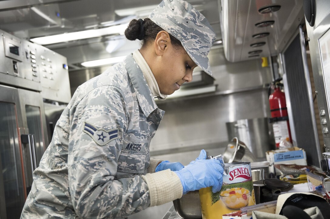 U.S. Air Force Airman 1st Class Kayla Akers, from the 116th Air Control Wing (ACW) Services Flight, Georgia Air National Guard (ANG), open a can of fruit cocktail while preparing dinner for joint-forces personnel supporting the 58th Presidential Inauguration, Washington, D.C., January 19, 2017. A team of 10 Airmen from the 116th ACW deployed with their Disaster Relief Mobile Kitchen Trailer, or DRMKT. Working from FedEx Field, home to the Washington Redskins, the team worked along side services teams from other ANG units across the nation preparing and serving meals to about 3,500 joint-force members per day deployed to the National Capital Region. In all, about 7,500 National Guard Soldiers and Airmen, from 44 states, three territories and the District of Columbia, served with the specially created Joint Task Force – District of Columbia. As a whole, National Guard Soldiers and Airmen augmented the U.S. Secret Service, U.S. Capitol Police and D.C. Metropolitan Police forces on a range of support including traffic control, crowd management, logistics and communication. (U.S. Air National Guard photo by Senior Master Sgt. Roger Parsons)