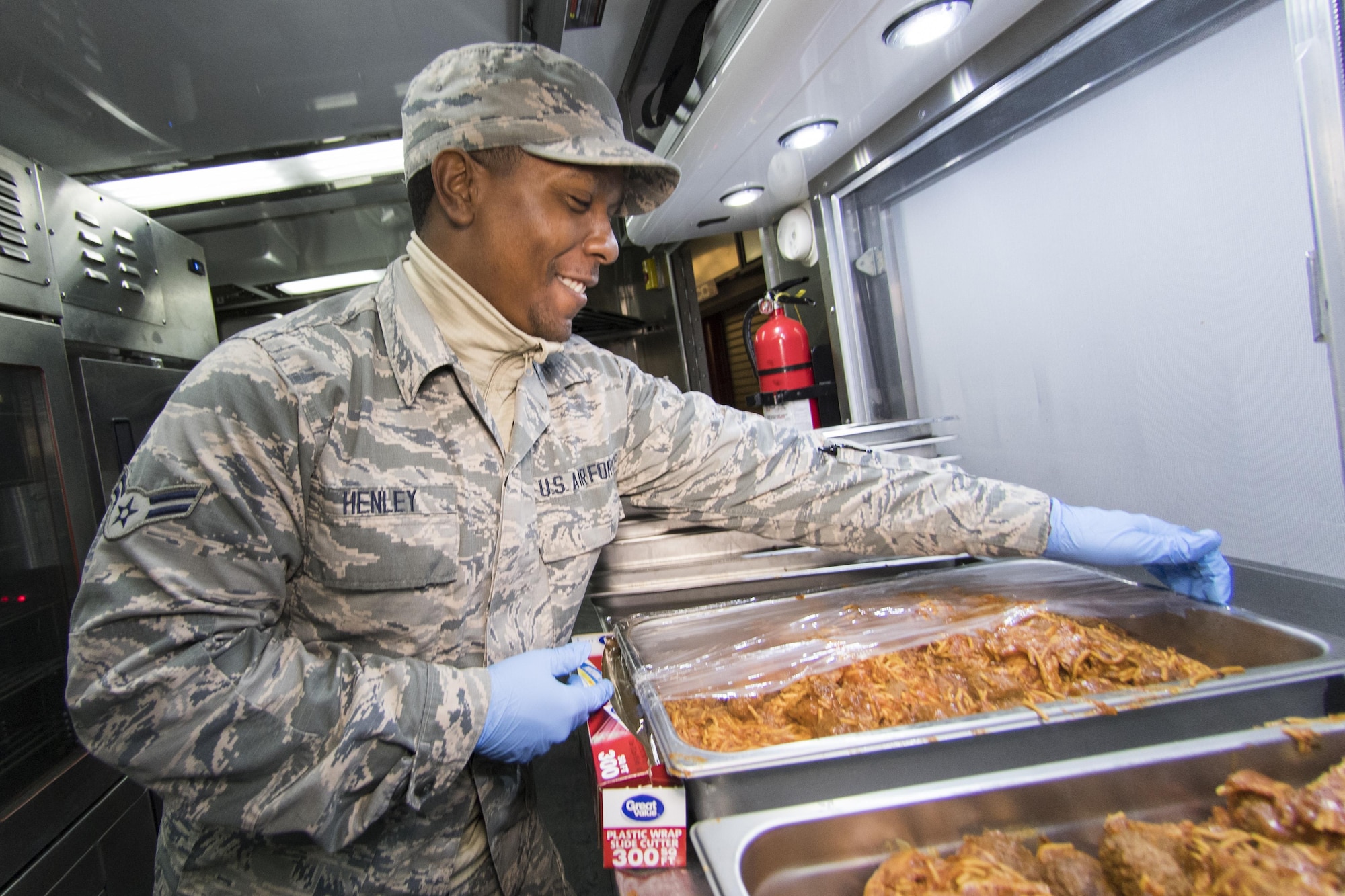 U.S. Air Force Airman 1st Class Dasmon Henley from the 116th Air Control Wing (ACW) Services Flight, Georgia Air National Guard (ANG), prepares a tray of spaghetti during dinner preparation for joint-forces personnel supporting the 58th Presidential Inauguration, Washington, D.C., January 18, 2017. A team of 10 Airmen from the 116th ACW deployed with their Disaster Relief Mobile Kitchen Trailer (DRMKT).  Working from FedEx Field, home to the Washington Redskins, the team worked along side services teams from other ANG units across the nation preparing and serving meals to about 3,500 joint-force members per day deployed to the National Capital Region. In all, about 7,500 National Guard Soldiers and Airmen, from 44 states, three territories and the District of Columbia, served with the specially created Joint Task Force – District of Columbia. As a whole, National Guard Soldiers and Airmen augmented the U.S. Secret Service, U.S. Capitol Police and D.C. Metropolitan Police forces on a range of support including traffic control, crowd management, logistics and communication. (U.S. Air National Guard photo by Senior Master Sgt. Roger Parsons)