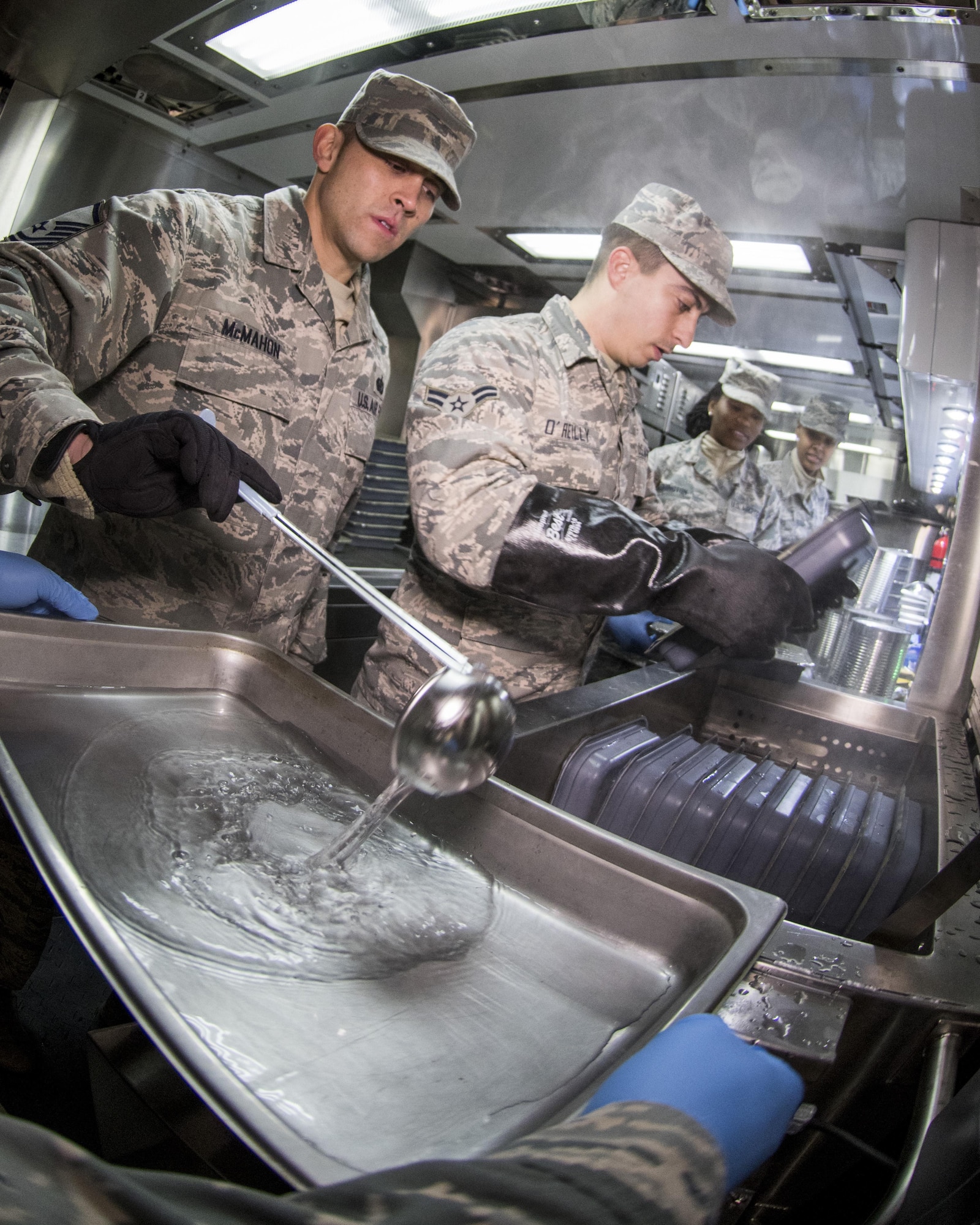 U.S. Air Force Airmen from the 116th Air Control Wing (ACW) Services Flight, Georgia Air National Guard (ANG), prepare dinner for joint-forces personnel supporting the 58th Presidential Inauguration, Washington, D.C., January 18, 2017. A team of 10 Airmen from the 116th ACW deployed with their Disaster Relief Mobile Kitchen Trailer (DRMKT).  Working from FedEx Field, home to the Washington Redskins, the team worked along side services teams from other ANG units across the nation preparing and serving meals to about 3,500 joint-force members per day deployed to the National Capital Region. In all, about 7,500 National Guard Soldiers and Airmen, from 44 states, three territories and the District of Columbia, served with the specially created Joint Task Force – District of Columbia. As a whole, National Guard Soldiers and Airmen augmented the U.S. Secret Service, U.S. Capitol Police and D.C. Metropolitan Police forces on a range of support including traffic control, crowd management, logistics and communication. (U.S. Air National Guard photo by Senior Master Sgt. Roger Parsons)