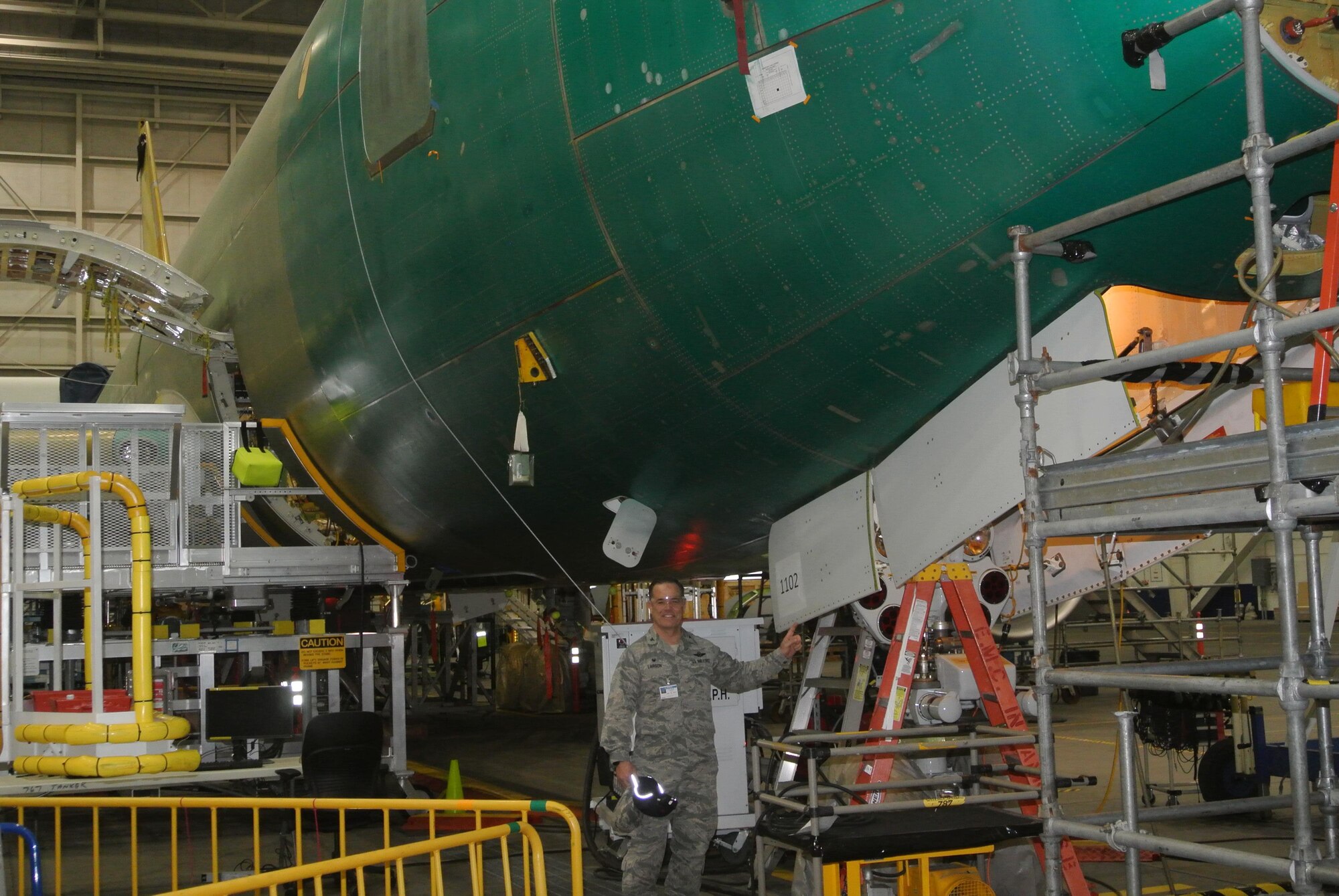 Col. Mark S. Larson poses with a future "member" of Team McConnell, Jan. 19, 2017,  at the Boeing Facility located in Everett, Wash. The KC-46A Pegasus is the first of the next-generation tankers scheduled to be delivered to the base later this year. The new aircraft will eventually replace the Air Force’s aging KC-135 Stratotanker fleet. (Courtesy photo)