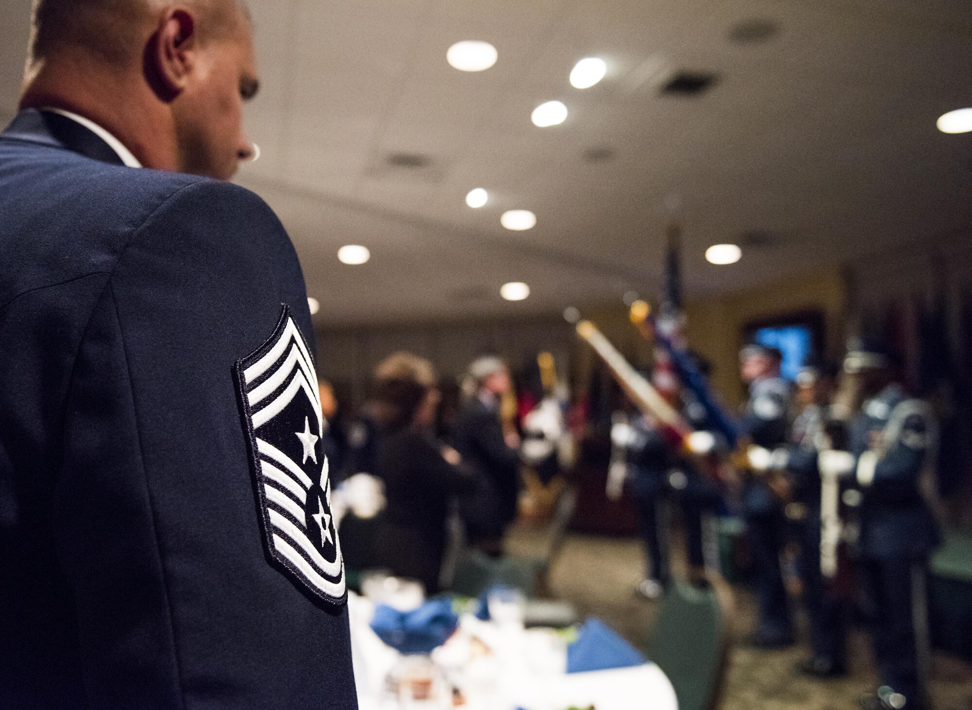 A command chief master sergeant stands during the presentation of the colors during a recognition ceremony Jan. 20 at Eglin Air Force Base, Fla.  Six new chiefs were recognized during the formal ceremony and dinner.  (U.S. Air Force photo/Samuel King Jr.)