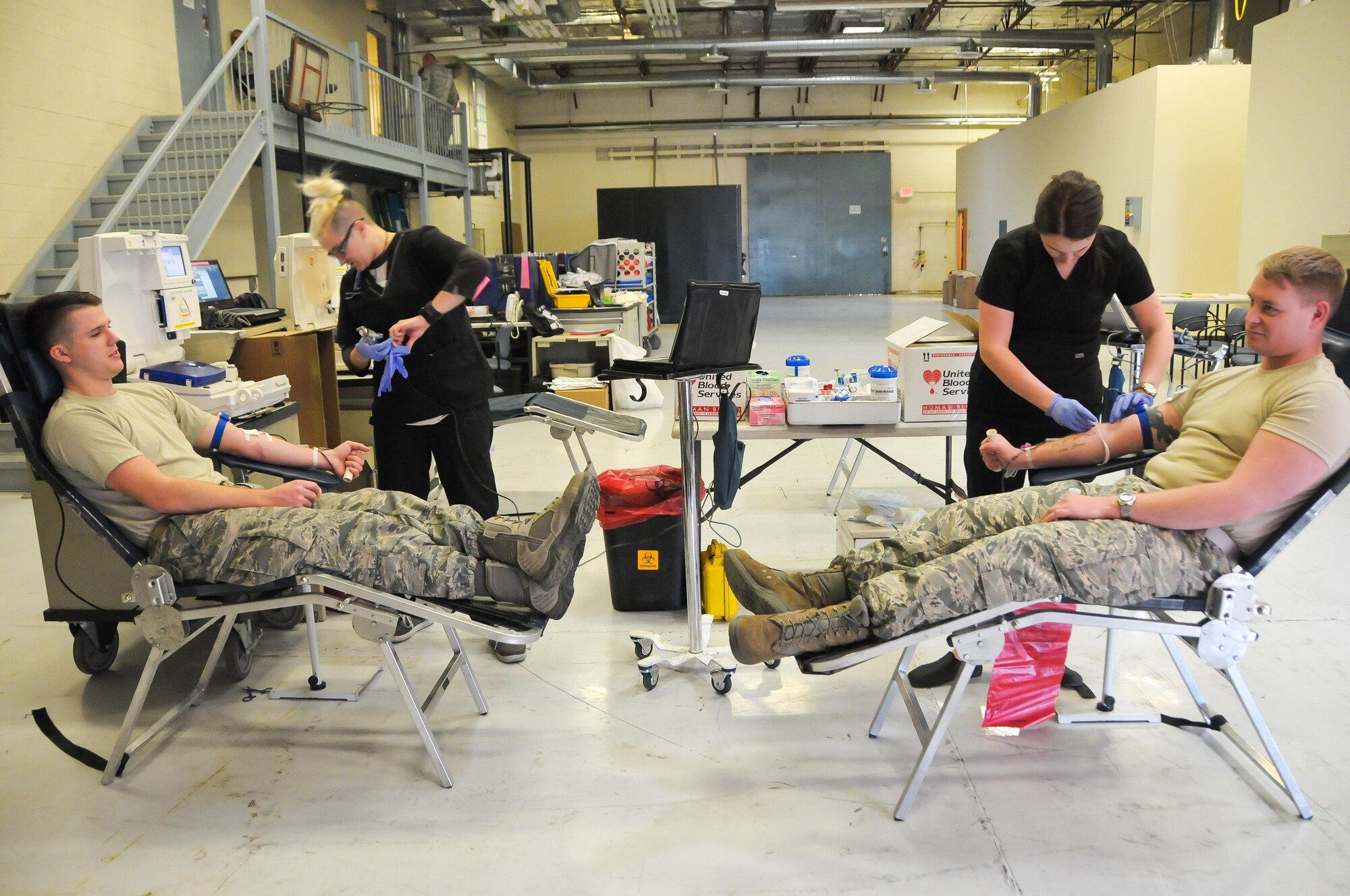 Staff Sgts. Stephen Cloherty and Eric Schult, both material management journeymen with the 944th Logistics Readiness Squadron, donate blood Jan. 8 during the 944th Fighter Wing Blood Drive. More than 30 of Luke’s Citizen Airmen turned out to donate XX pints of blood. United Blood Services, a non-profit community blood center founded in Phoenix, Ariz. in 1943, provides blood and blood products to more than 500 hospitals across the United States. (U.S. Air Force photo by Staff Sgt. Nestor Cruz)