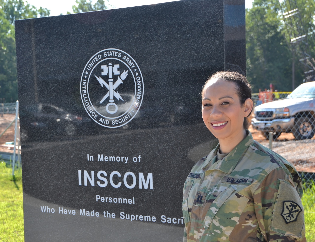 Army Capt. Raven Cornelius stands beside the memorial outside U.S. Army Intelligence and Security Command headquarters at Fort Belvoir, Va., Aug. 26, 2016. Army photo by Ron Young