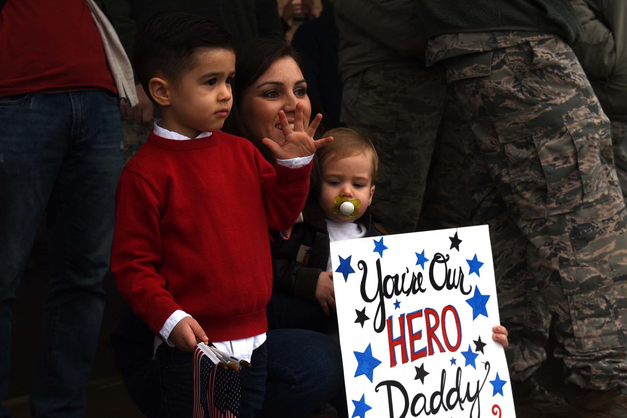 A family eagerly awaits the return of a U.S. Air Force Airman from a six-month deployment to Southwest Asia Jan. 19, 2017, at Little Rock Air Force Base, Ark. Team Little Rock Airmen specialize in providing rapid, global mobility to support humanitarian and wartime operations. (U.S. Air Force photo by Airman 1st Class Kevin Sommer Giron)