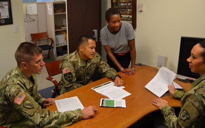 Army Capt. Raven Cornelius, right, briefs U.S. Army Intelligence and Security Command Acquisition Center staff members, from left, Army Sgt. 1st Class John Wysocki, Army Maj. Ryan Ocampo and Betty Jarman at Fort Belvoir, Va., Aug. 26, 2016. Army photo by Ron Young