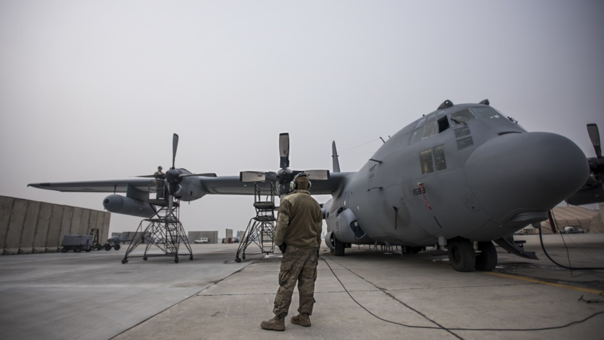 Staff Sgt. Kyle Poston, 455th Expeditionary Aircraft Maintenance Squadron crew chief, oversees engine maintenance on an EC-130 Compass Call Jan. 18, 2017 at Bagram Airfield, Afghanistan. To date, 41st EECS crews have flown over 39,000 hours during 6,800 combat sorties in support of Operation Enduring Freedom, and now the Resolute Support Mission. (U.S. Air Force photo by Staff Sgt. Katherine Spessa)
