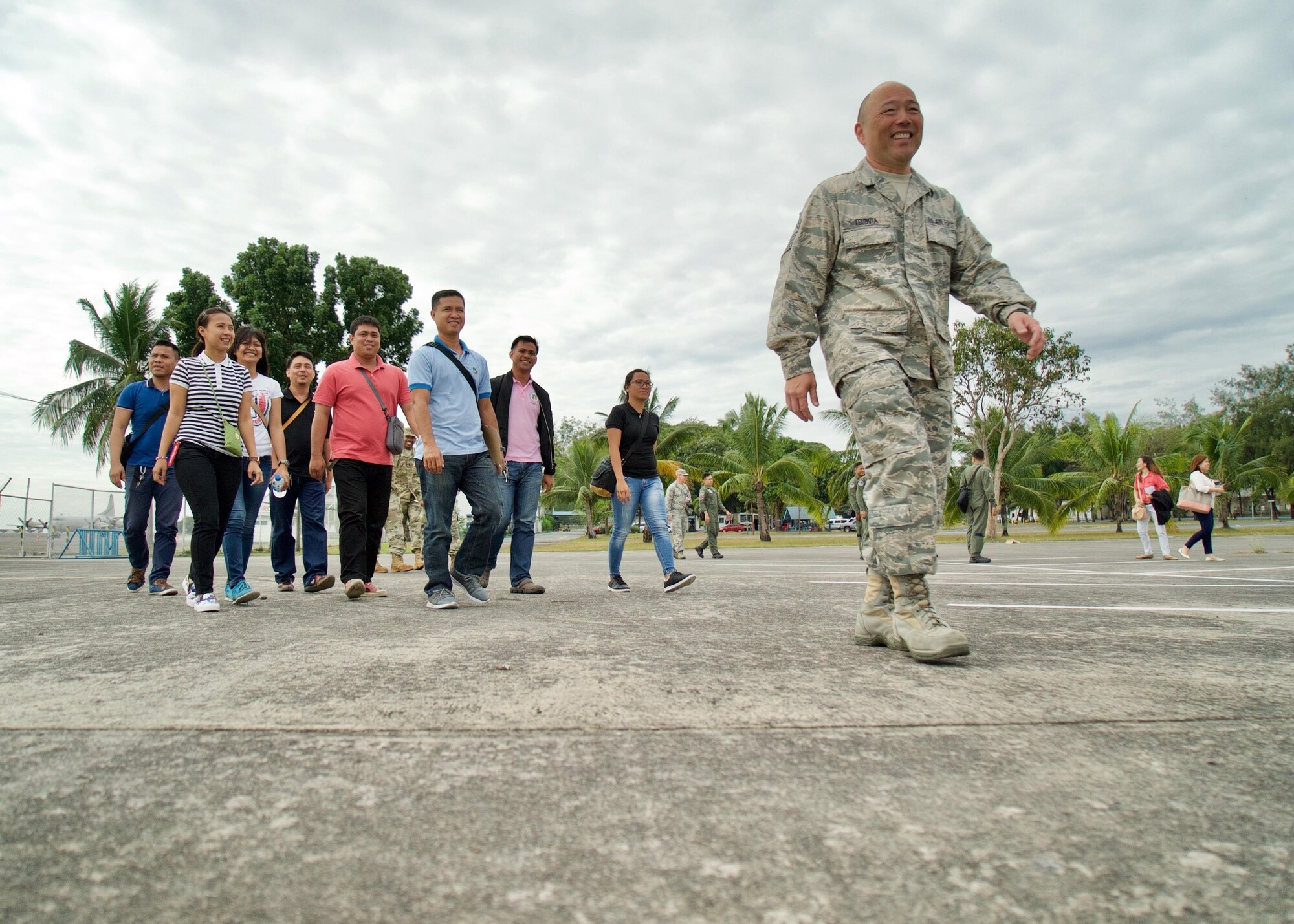 U.S. Air Force Chief Master Sgt. Reid Tsubota, Eagle Vision superintendent, leads a group of Phillipine Air Force members on a tour of the Eagle Vision work site, Clark Air Base, Philippines, Jan. 16, 2017. Tsubota and the Philippine Airmen are participating in a Subject Matter Expert Exchange (SMEE) by the U.S. Air Force. The goal of the SMEE is to bring together both nations' air forces to enhance their combined readiness through satellite imagery and planning Humanitarian Assistance and Disaster Relief operations common in the Asia-Pacific. (U.S. Air Force photo by Tech. Sgt. James Stewart/Released)