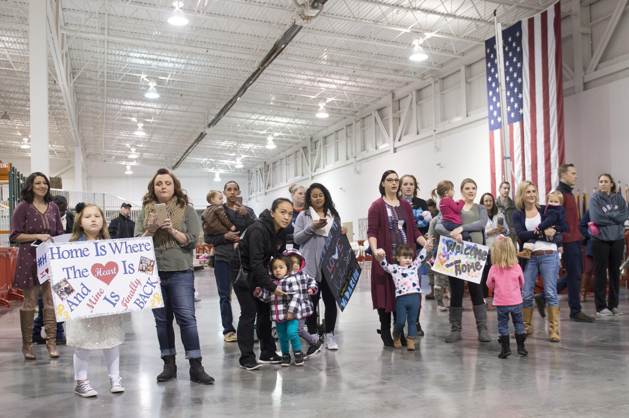 Family and friends await the return of Airmen from the 621st Contingency Response Wing, Jan. 14, 2017, at Travis Air Force Base, California. The Airmen were returning from a three-month deployment to Iraq, in support of Operation Inherent Resolve. (U.S. Air Force Photo by Tech. Sgt. Liliana Moreno)