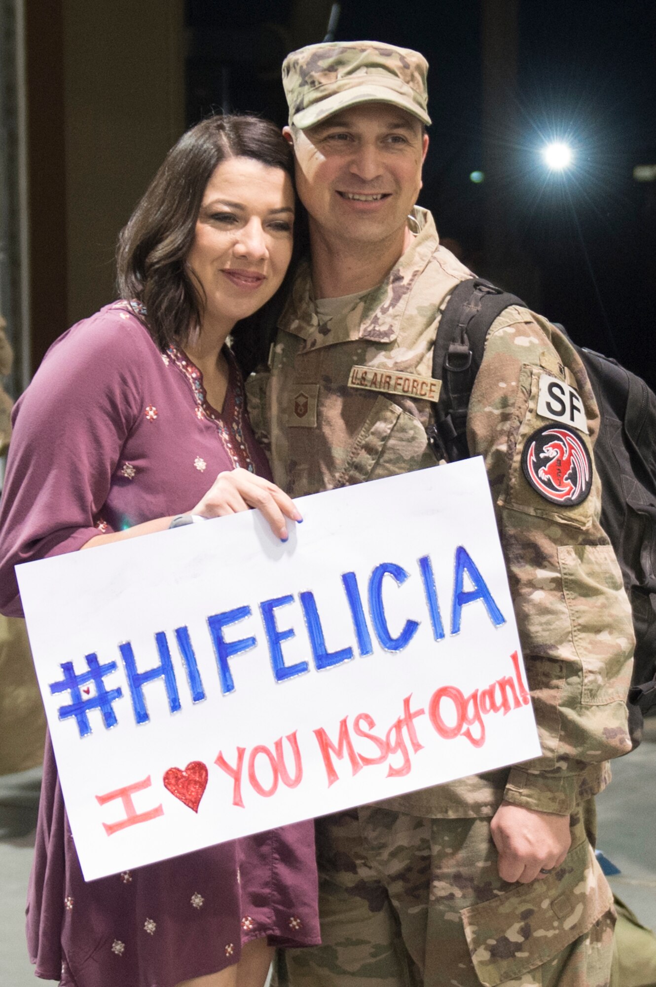 Master Sgt. Matthew Ogan, 921st Contingency Response Squadron Force Protection Flight chief, poses for a picture with his wife as he returns from a three-month deployment to Iraq, in support of Operation Inherent Resolve, Jan. 14, 2017, at Travis Air Force Base, California.  The CRW played a crucial role in re-opening Qayyarah West Airfield and moving more than 1,423 short tons of cargo in and out of the region. (U.S. Air Force Photo by Tech. Sgt. Liliana Moreno)
