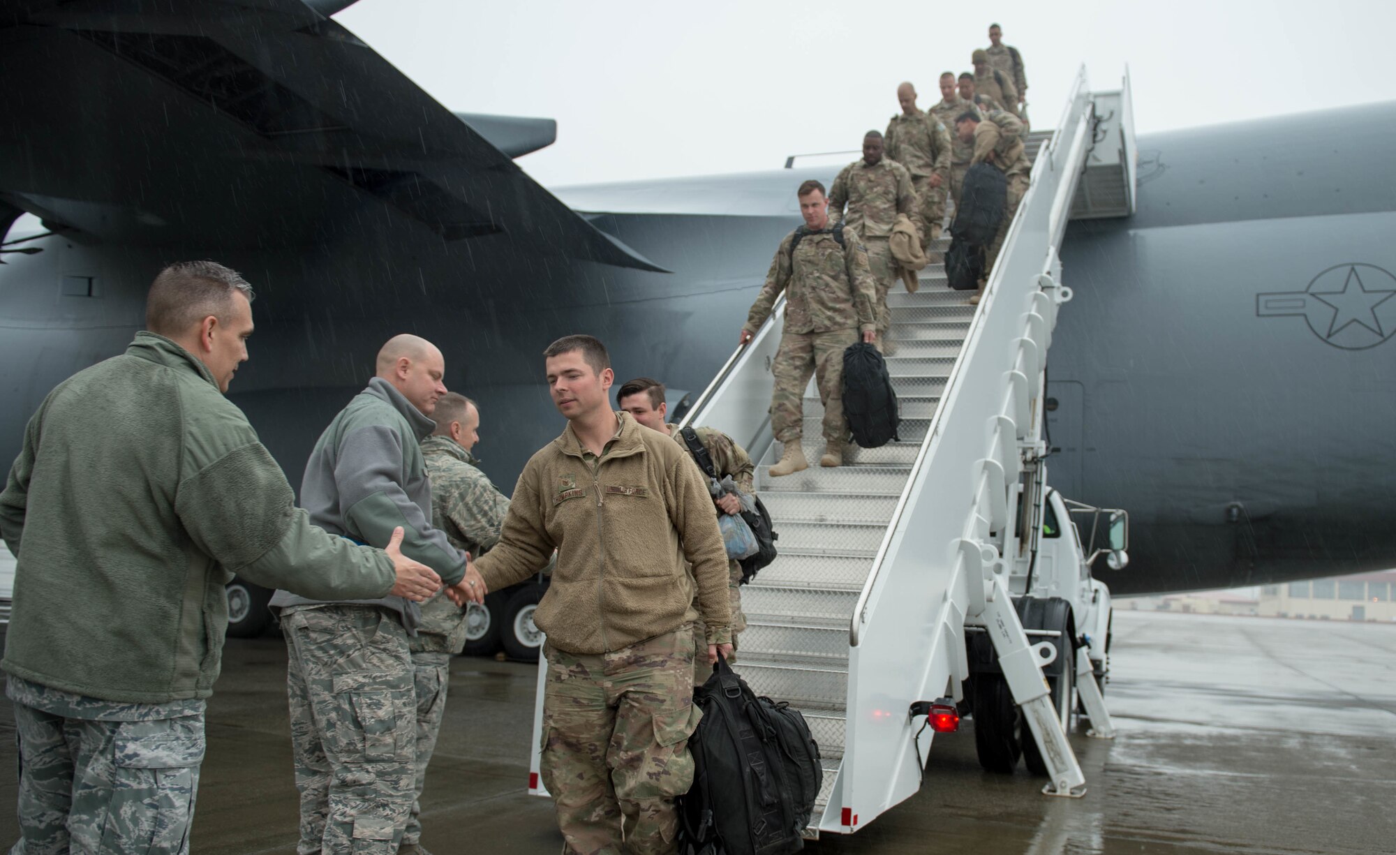 621st Contingency Response Wing leadership greets Airmen as they return from a three-month deployment to Iraq, in support of Operation Inherent Resolve, Jan. 18, 2017, at Travis Air Force Base, California. The CRW played a crucial role in reopening Qayyarah West Airfield and moving more than 1,423 short tons of cargo in and out of the region. (U.S. Air Force Photo by Staff Sgt. Robert Hicks)