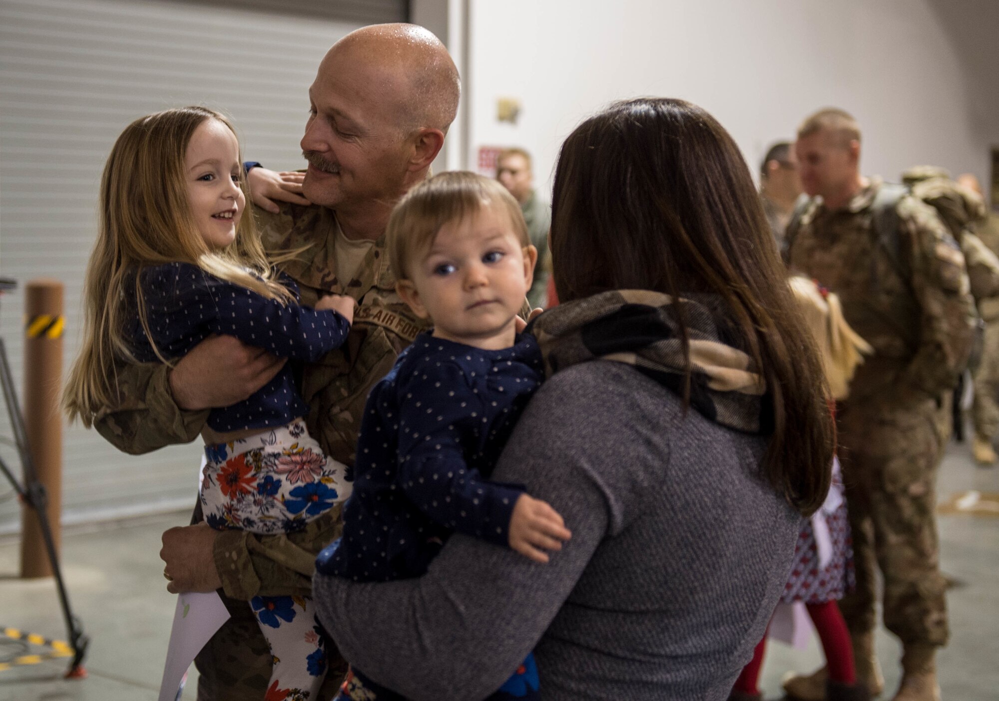 Lt. Col. Blaine Baker, 821st Contingency Response Element commander, hugs his daughter as he returns from a three-month deployment to Iraq, in support of Operation Inherent Resolve, Jan. 18, 2017, at Travis Air Force Base, California. The CRW played a crucial role in reopening Qayyarah West Airfield and moving more than 1,423 short tons of cargo in and out of the region. (U.S. Air Force Photo by Staff Sgt. Robert Hicks)