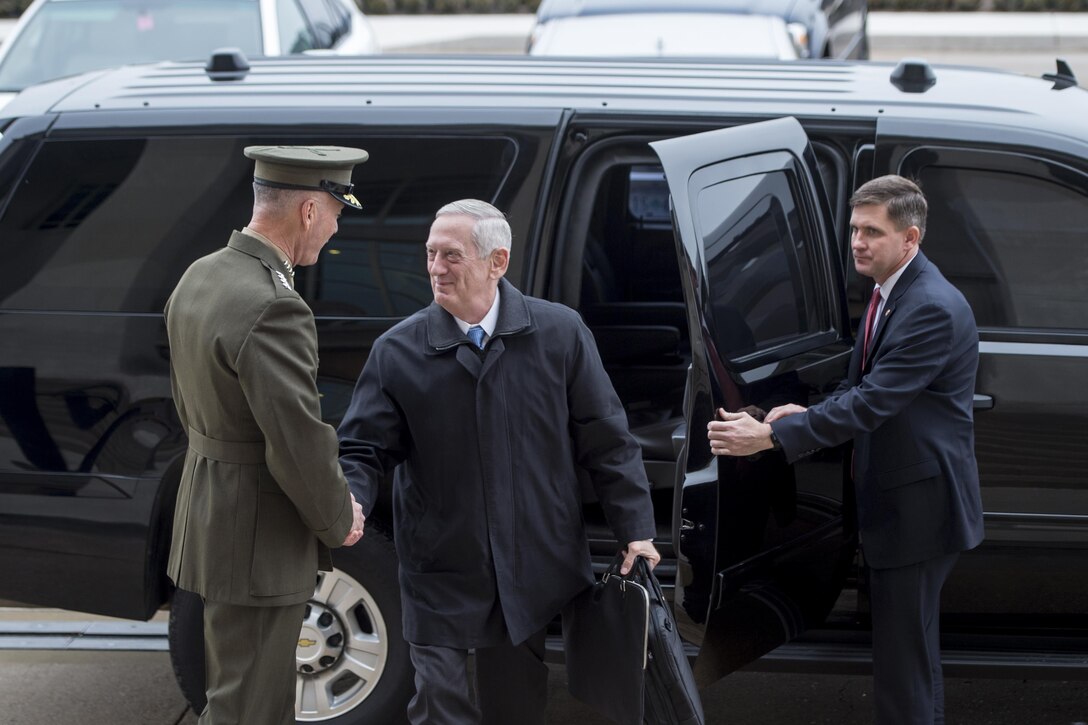 Defense Secretary Jim Mattis exchanges greetings with Marine Corps Gen. Joe Dunford, chairman of the Joint Chiefs of Staff, upon arriving at the Pentagon for his first full day as secretary, Jan. 21, 2017. DoD photo by Air Force Tech. Sgt. Brigitte N. Brantley