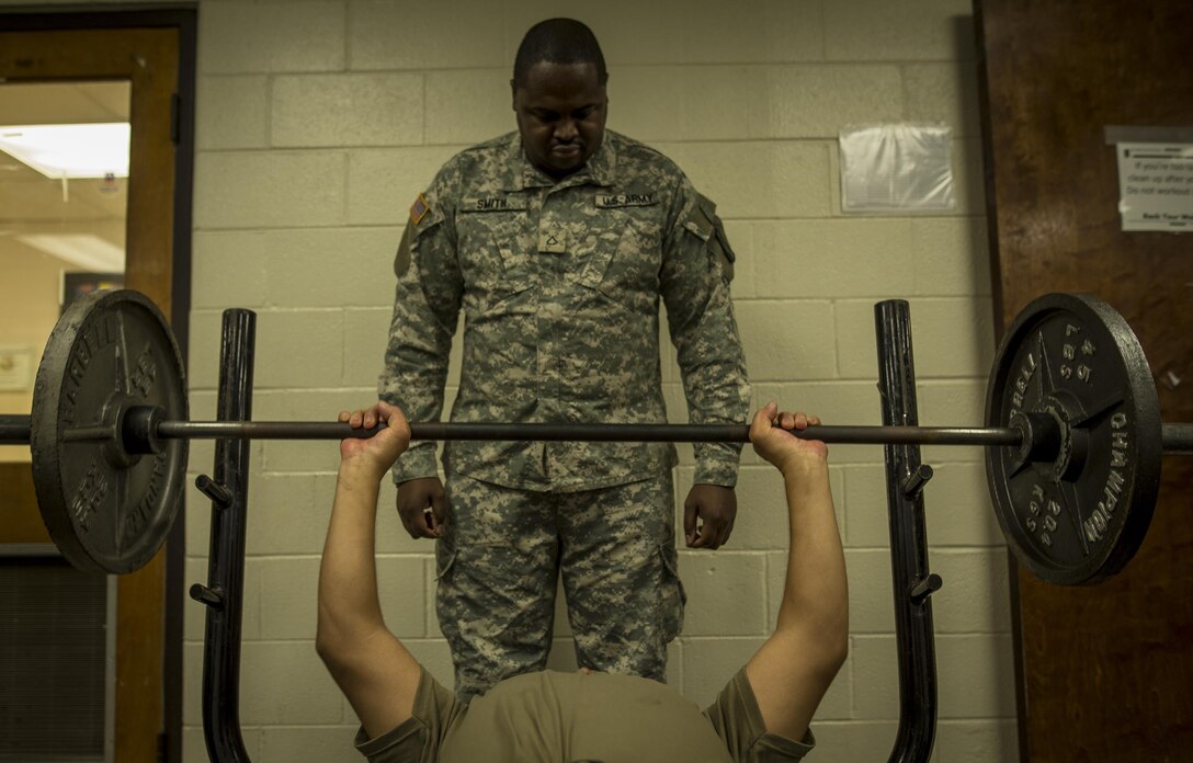 U.S. Army Reserve Private 1st Class Dunta Smith, a logistical supply specialist from Atlanta, Ga., spots Sgt. Christopher Duncan, of Columbus, Ga., as they exercise during their lunch break in the 335th Signal Command (Theater) headquarters building in East Point, Ga., Jan. 21, 2017. Both soldiers are with Charlie Company, 324th Expeditionary Signal Battalion.