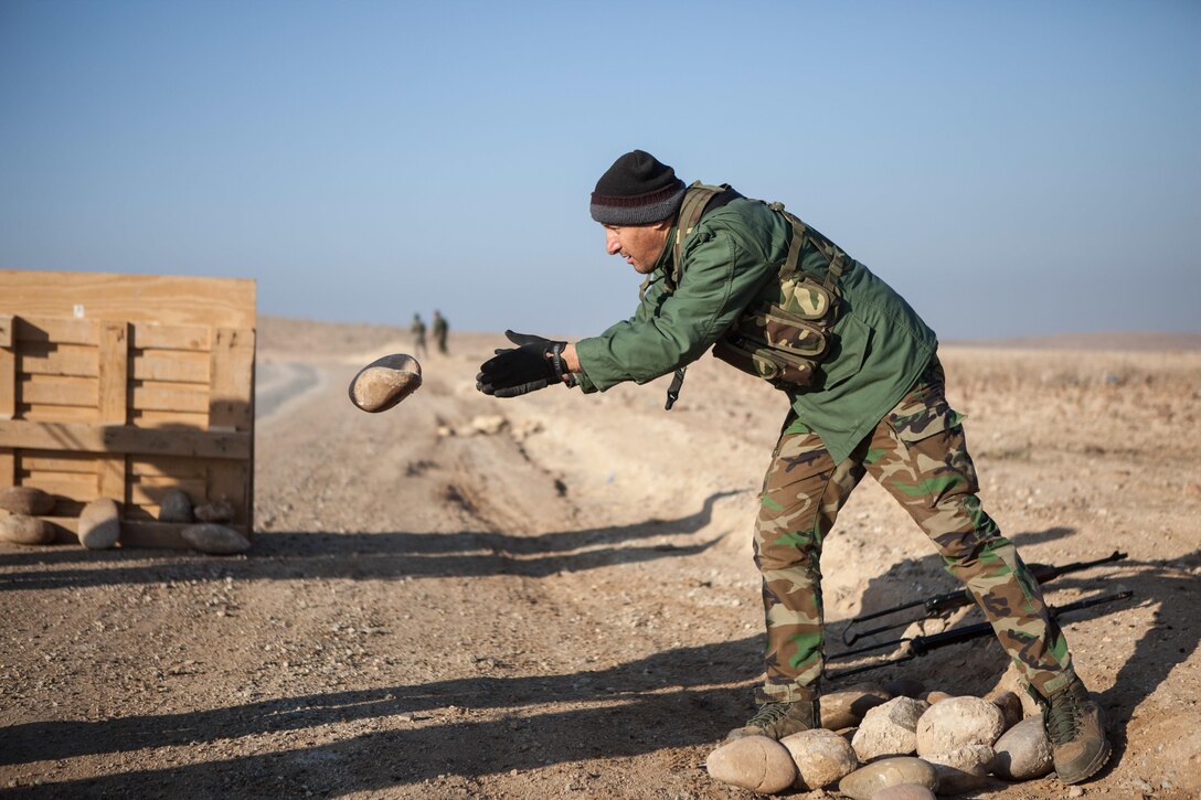 A Peshmerga soldier moves boulders to help prepare a barrier during mobile checkpoint training at Black Tigers Training Camp, Iraq, Jan. 19, 2017.  This training is part of the overall Combined Joint Task Force – Operation Inherent Resolve building partner capacity mission. CJTF-OIR is the global Coalition to defeat ISIL in Iraq and Syria. (U.S. Army photo by Sgt. Josephine Carlson)