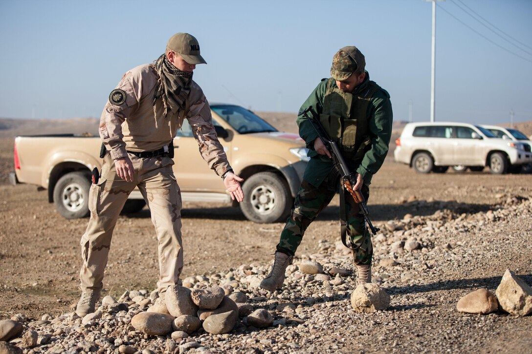 A Dutch trainer instructs a Peshmerga soldier on the proper way to set up a barrier during mobile checkpoint training at Black Tigers Training Camp, Iraq, Jan. 19, 2017. The Netherlands is one of many coalition partners who are part of the Combined Joint Task Force – Operation Inherent Resolve building partner capacity mission dedicated to training Iraqi security forces.  CJTF-OIR is the global Coalition to defeat ISIL in Iraq and Syria. (U.S. Army photo by Sgt. Josephine Carlson)