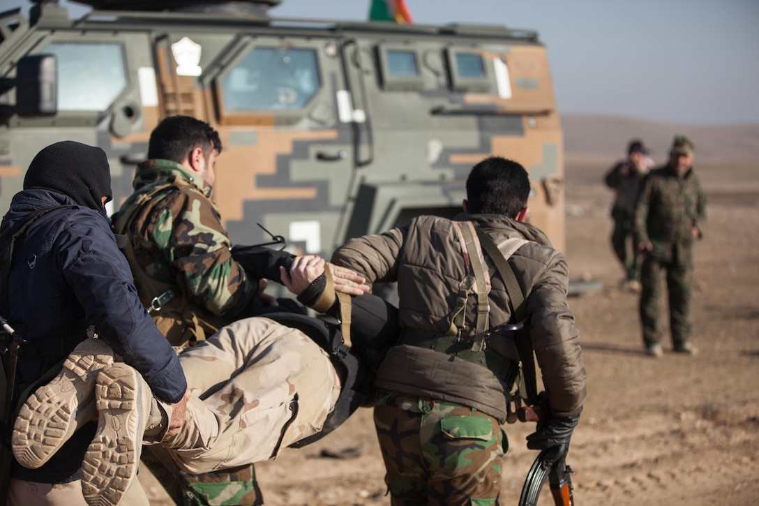 Peshmerga soldiers carry a Dutch trainer to their vehicle after he resisted questioning during a simulated mobile checkpoint scenario at Black Tigers Training Camp, Iraq, Jan. 19, 2017. The Netherlands is one of many coalition partners who are part of the Combined Joint Task Force – Operation Inherent Resolve building partner capacity mission dedicated to training Iraqi security forces.  CJTF-OIR is the global Coalition to defeat ISIL in Iraq and Syria. (U.S. Army photo by Sgt. Josephine Carlson)