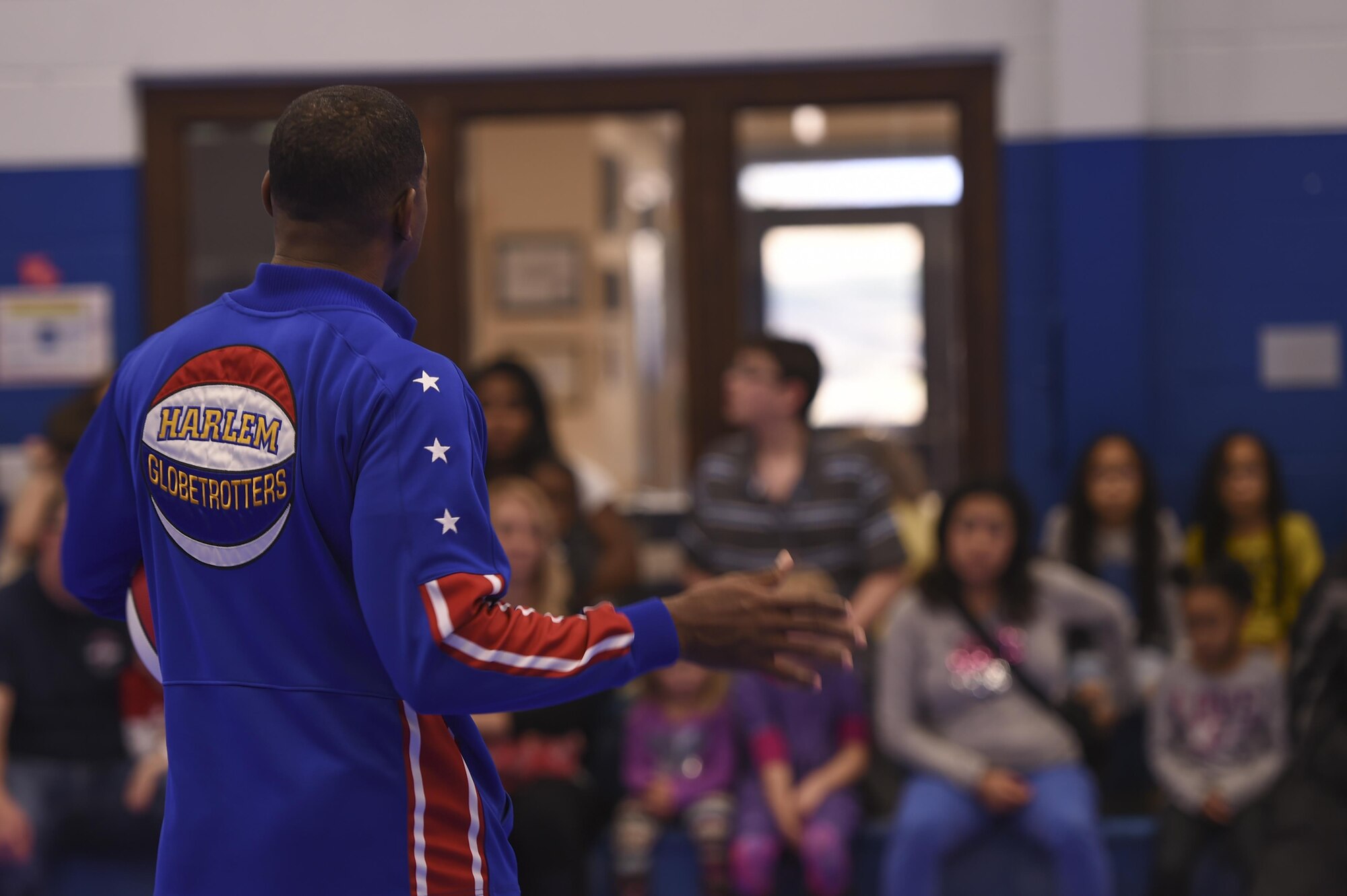Anthony “Buckets” Blakes, a Harlem Globetrotters point guard, explains the history of his team to a group of military families, Jan. 20, 2017, at the Little Rock Air Force Base Youth Center, Ark. The basketball player and his teammates will perform in North Little Rock, Ark., Jan. 31, 2017. (U.S. Air Force photo by Senior Airman Harry Brexel)