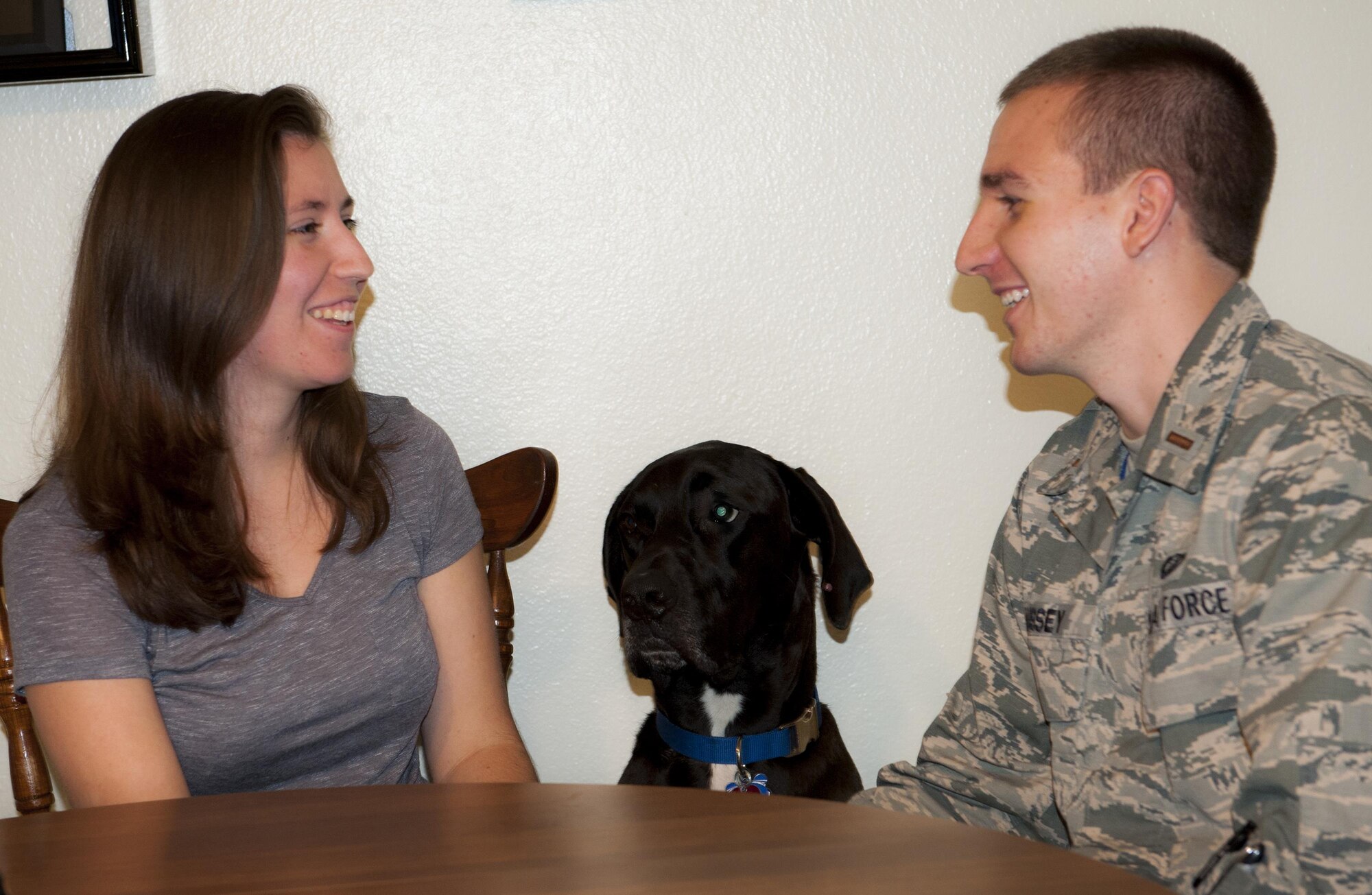 Olivia Hussey and her husband, 2nd Lt. Tyler Hussey, 36th Electronic Warfare Squadron, talk about each other’s day as Duke, their Great Dane, listens.  Hussey recently attended a Heart Link workshop at Eglin Air Force Base, Fla.’s Airman & Family Readiness Center, where she learned about various aspects of military life.  (U.S. Air Force photo/Kevin Gaddie)