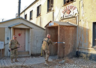 The Commander of the 1st Combat Aviation Brigade Col. John M. Cyrulik stands at the ready waiting to take a swing with his sledge hammer to the old MEDVAC facility.  The 389th Engineer Company, 368th Engineer Battalion, 176th Engineer Brigade, built a new MEDVAC facility which will house members of Charlie Company, 2nd Battalion, 1st Aviation Regiment (General Support Aviation Battalion) from Ft. Riley, Kan. (“Boomer Dust-off”). (DOD photo by Jet Fabara)