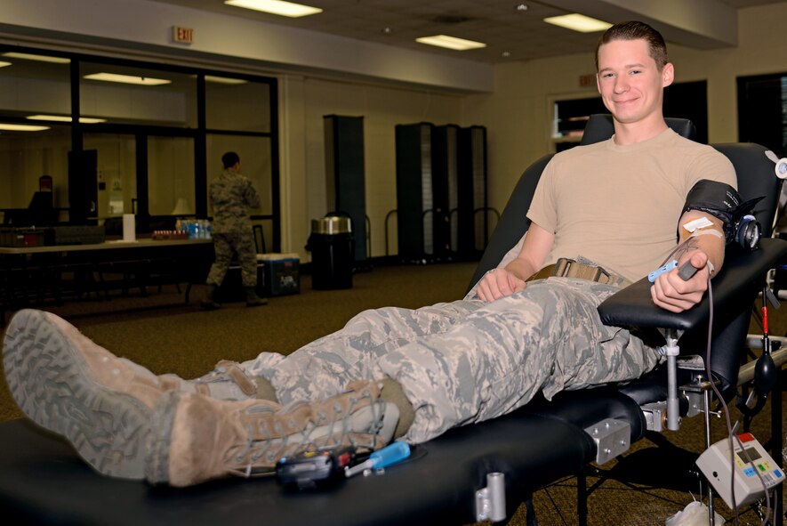 U.S. Air Force Senior Airman Mike Strickland, 20th Security Forces Squadron installation patrolman, sits on a donor bed while making his annual blood donation at a blood drive at Shaw Air Force Base, S.C., Jan. 20, 2017. Approximately 38 percent of the United States population is eligible to donate, but less than 10 percent give per year. (U.S. Air Force photo by Airman 1st Class Kathryn R.C. Reaves)