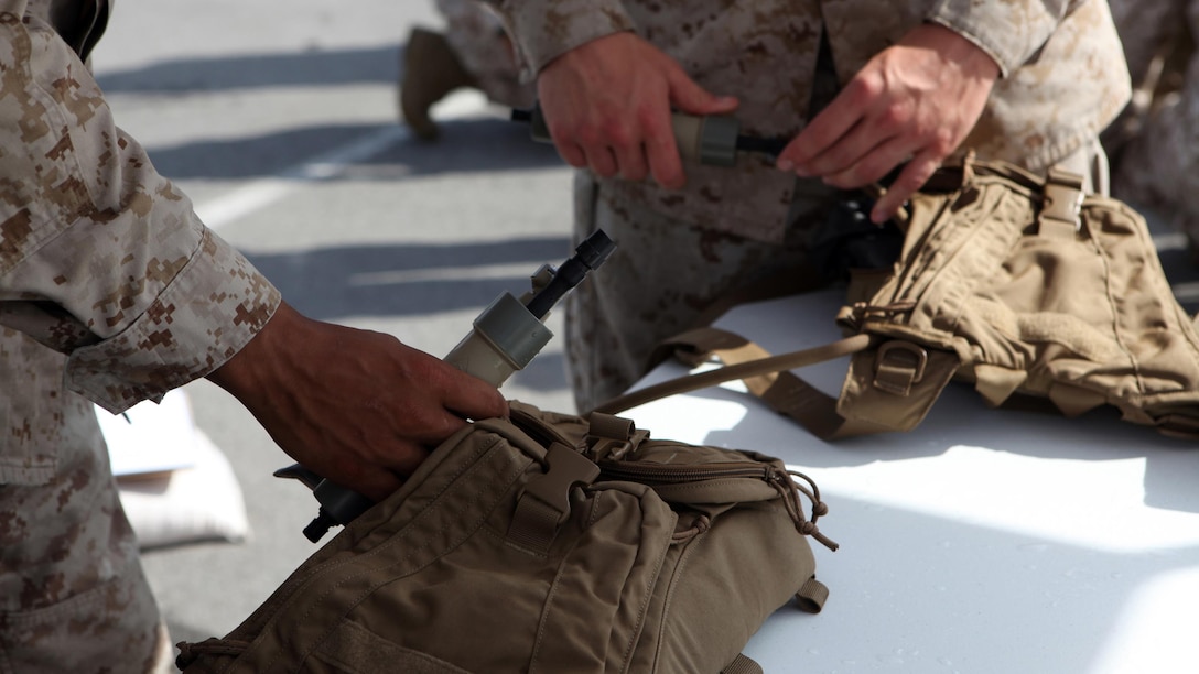 Marines, with the 22nd Marine Expeditionary Unit, attach water filters to hydration systems for evaluation during an Experimental Forward Operating Base aboard Marine Corps Base Camp Lejeune, N.C., May 4, 2012. Marines and sailors participating provided input on individual energy and water purification equipment. The Expeditionary Energy Office, Headquarters, Marine Corps, coordinated the XFOB for input from the servicemembers and suggestions for improvement.