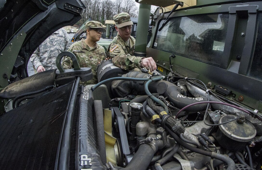 U.S. Army Reserve Spc. Daniel Knowles (right), an information technology specialist with the 335th Signal Command (Theater) from Warner Robins, Ga., teaches preventative maintenance checks and services to other Soldiers during training in the command’s motor pool in East Point, Ga., Jan. 22, 2017. 