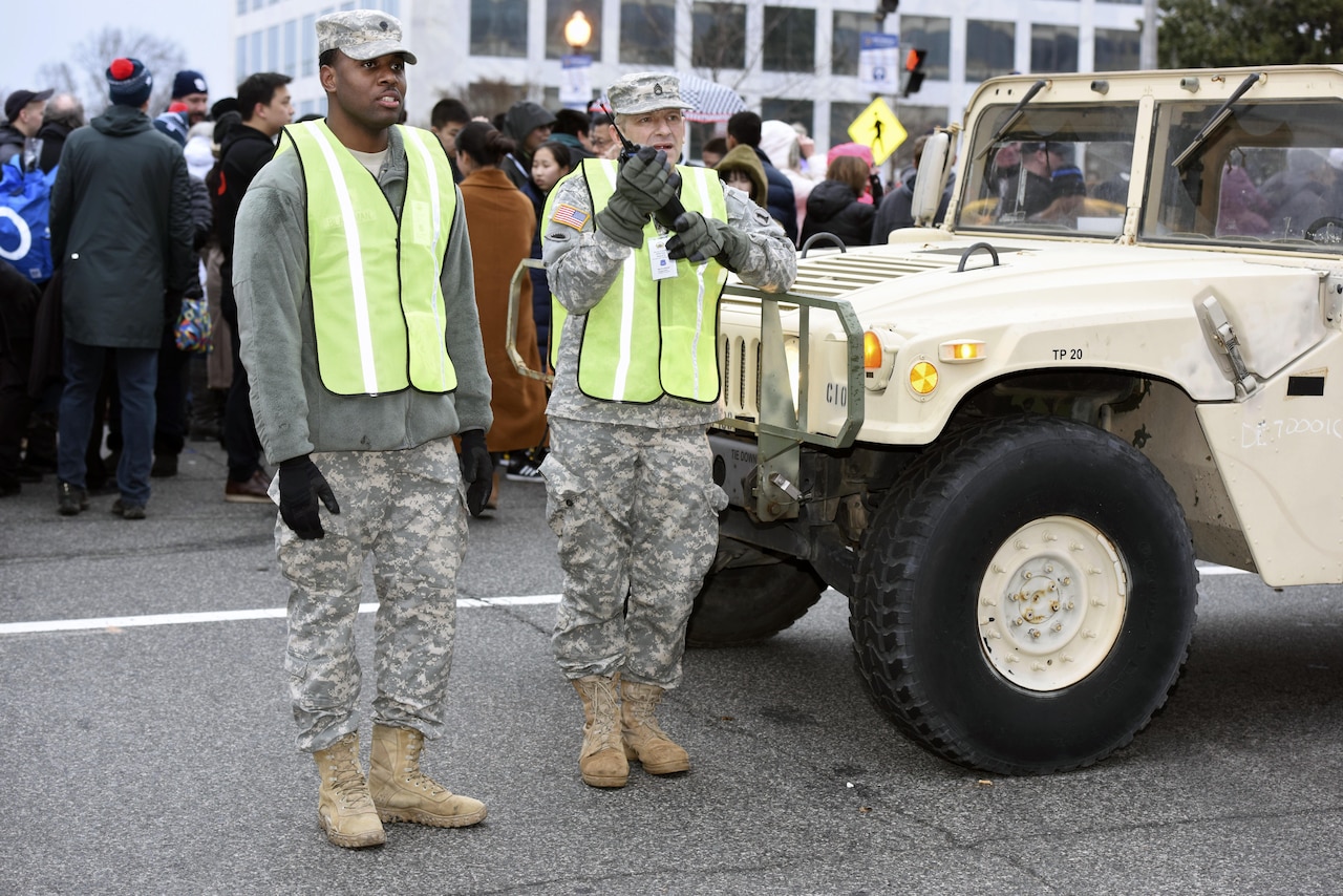 Spc. Shaleek Blackman, left, with the Delaware Army National Guard’s 153rd Military Police Company, and Army Staff Sgt. Eric Stunkard, with the Delaware Army Guard’s 262nd Component Repair Company, keep an eye out as crowds make their way to the National Mall for the 58th Presidential Inauguration in Washington, D.C., Jan. 20, 2017. The Soldiers were among more than 7,500 National Guard members from 44 states, territories and the District of Columbia, who supported local authorities during the inauguration. 