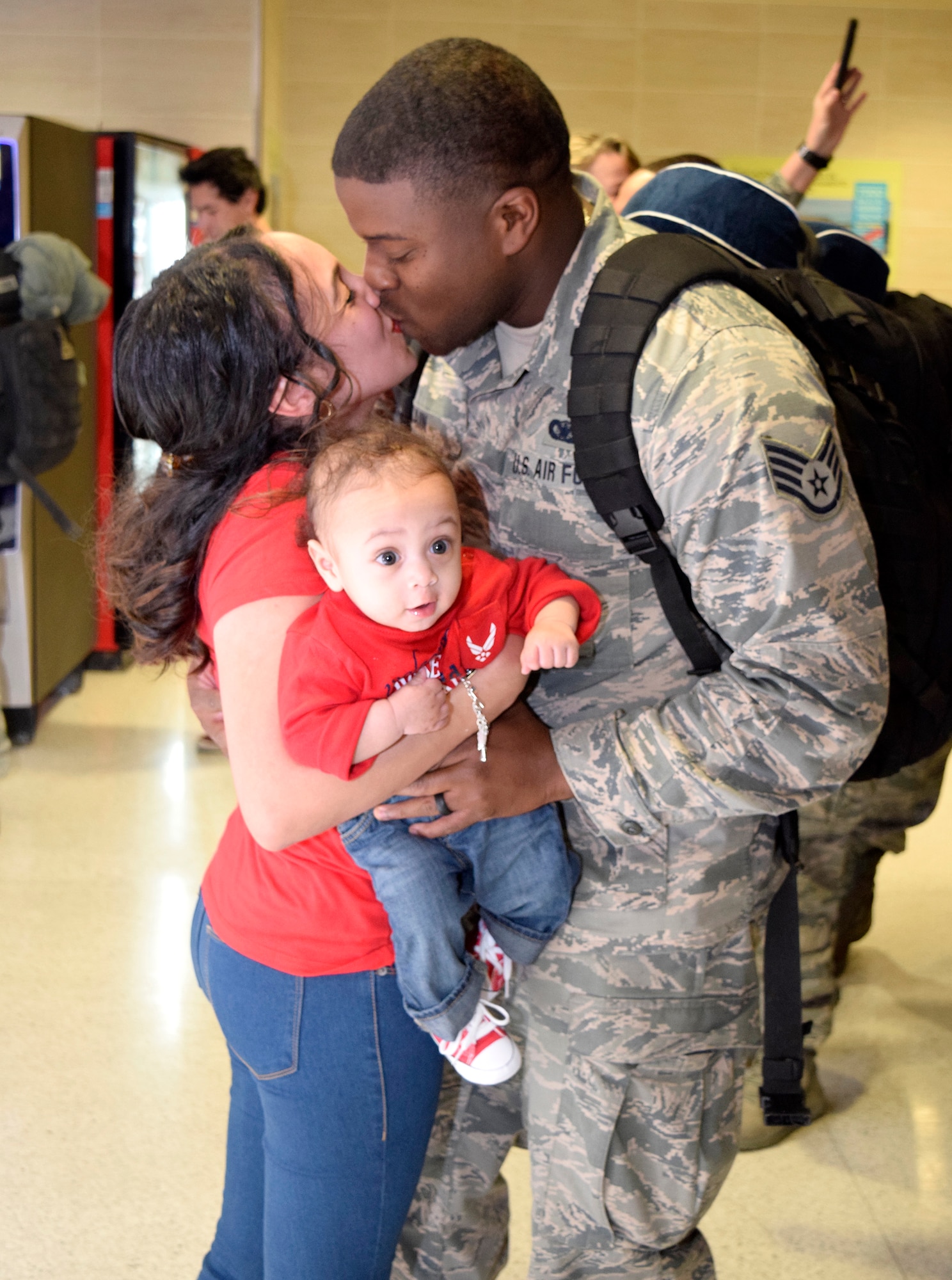Staff Sgt. Barrett Cain III, 433rd Security Forces Squadron, greats his wife, Krystal and his son, Cain IV, upon his return Jan. 19, 2017 at the San Antonio International Airport, Texas. Thirteen Citizen Airmen returned from a six-month deployment to Southwest Asia in support of Operation Inherent Resolve. 