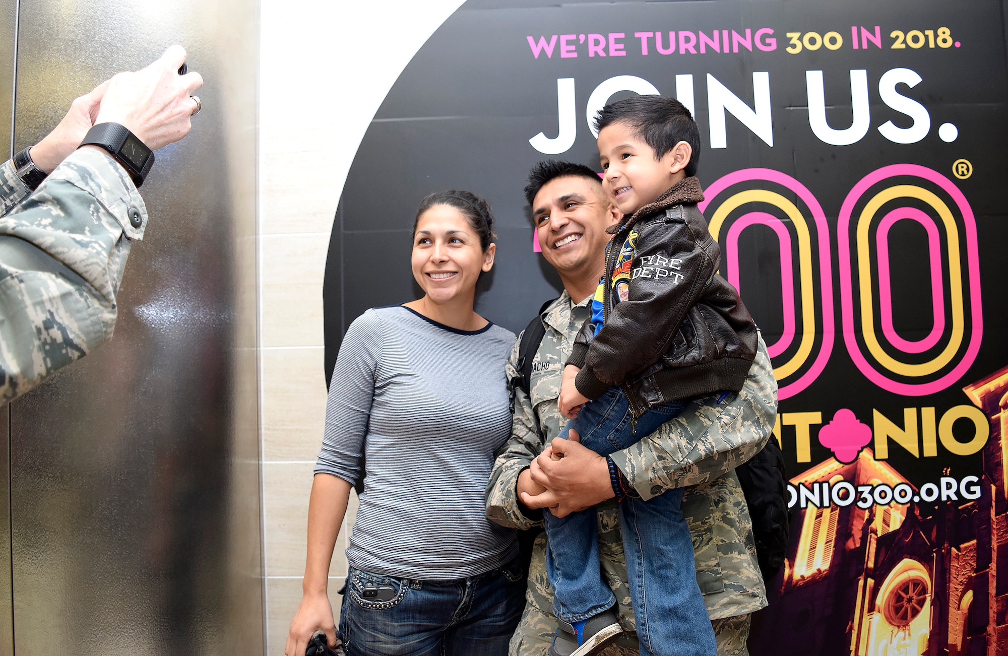 Master Sgt. Manuel Camacho, Jr., 433rd Security Forces Squadron, takes a moment with his son Adrian and SMSgt. Elena Ramirez, 433rd Aerospace Medicine Squadron upon his return Jan. 19, 2017 at the San Antonio International Airport, Texas. Thirteen Citizen Airmen returned from a six-month deployment to Southwest Asia in support of Operation Inherent Resolve. 