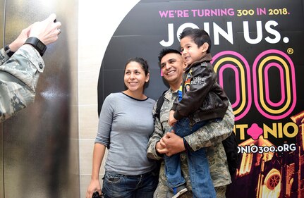 Master Sgt. Manuel Camacho, Jr., 433rd Security Forces Squadron, takes a moment with his son Adrian and SMSgt. Elena Ramirez, 433rd Aerospace Medicine Squadron upon his return Jan. 19, 2017 at the San Antonio International Airport, Texas. Thirteen Citizen Airmen returned from a six-month deployment to Southwest Asia in support of Operation Inherent Resolve. 