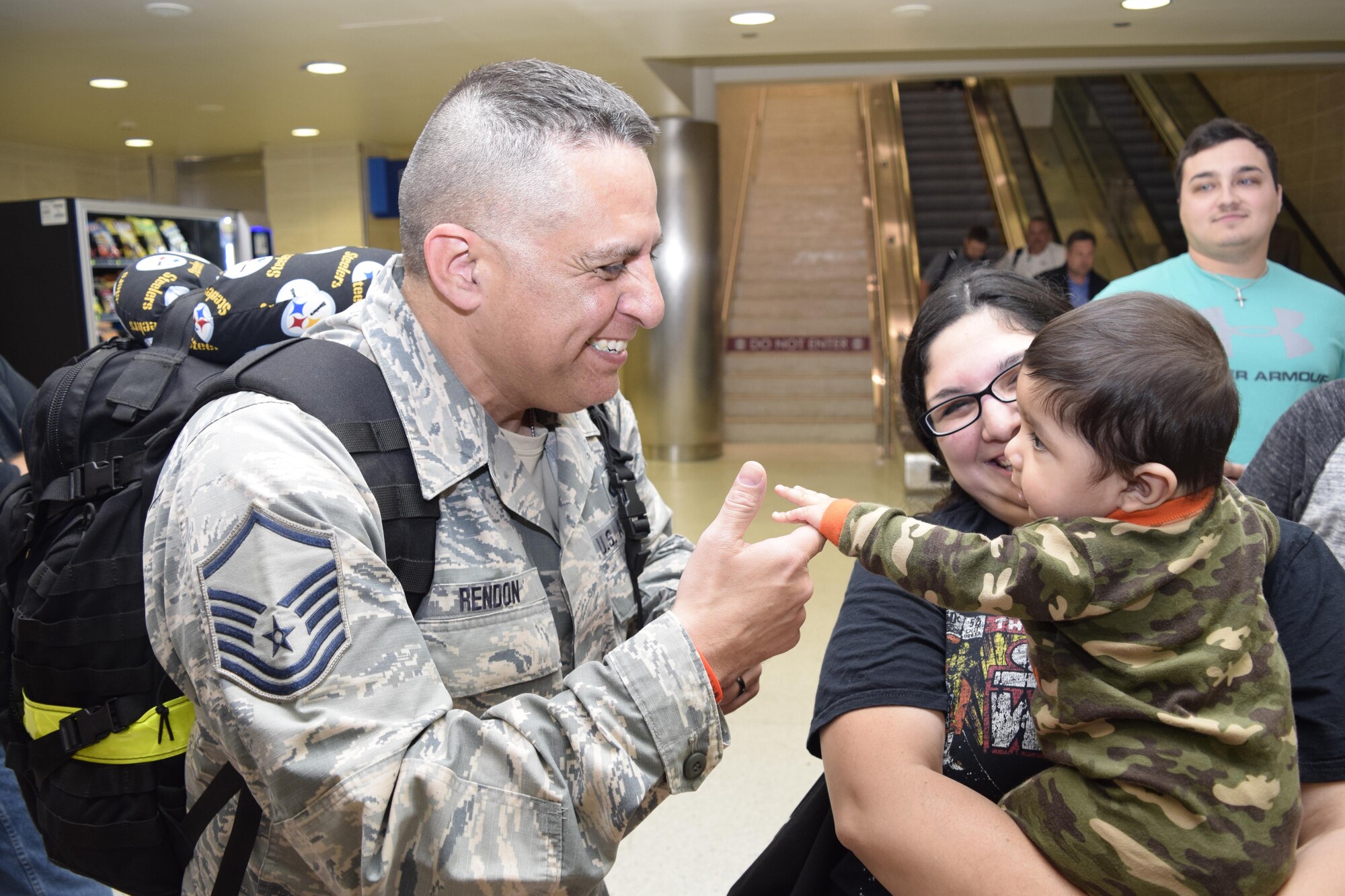Master Sgt. Rueben Rendon Jr., 433rd Security Forces Squadron, meets his grandson, Derreck Anguiano, for the first time upon his return Jan. 19, 2017 at the San Antonio International Airport, Texas. Thirteen Citizen Airmen returned from a six-month deployment to Southwest Asia in support of Operation Inherent Resolve. 
