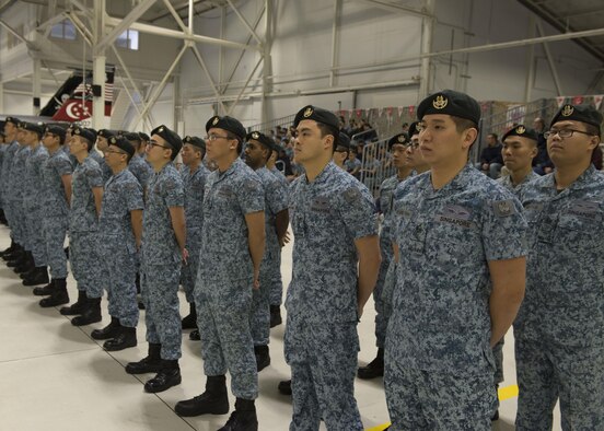 Republic of Singapore Air Force airmen stand at parade rest during a change of assignment ceremony at Mountain Home Air Force Base, Idaho, Jan. 17, 2017. Lt. Col. Oon Kok Choon became the Senior-ranking officer and Peace Carvin V Detachment Commander during the ceremony. (U.S. Air Force photo by Airman 1st Class Chester Mientkiewicz/Released)