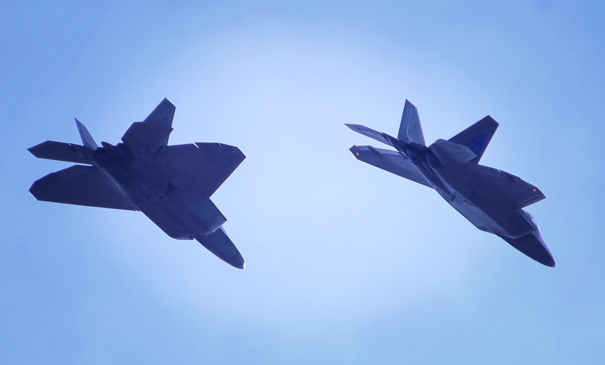 Two F-22 Raptors assigned to the 1st Fighter Wing, Joint Base Langley-Eustis, Va., break to land on Nellis Air Force Base, Nev., before Red Flag 17-1, Jan. 18, 2017. Red Flag is a realistic combat training exercise involving the air, space and cyber forces of the U.S. and its allies. (U.S. Air Force photo by Airman 1st Class Kevin Tanenbaum/Released) 