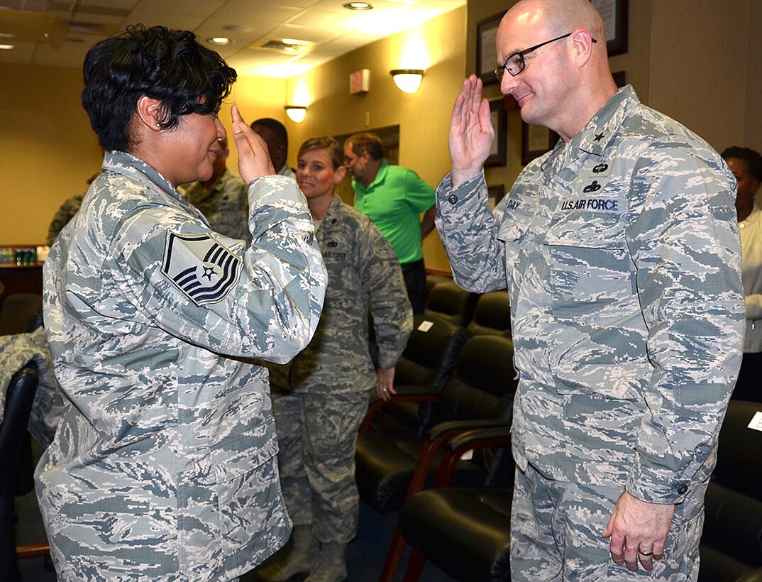 Defense Logistics Agency Aviation Commander Air Force Brig. Gen. Allan Day salutes Master Sgt. Nikki Broomfield after her promotion ceremony Jan. 19, 2017 on Defense Supply Center Richmond, Virginia.
