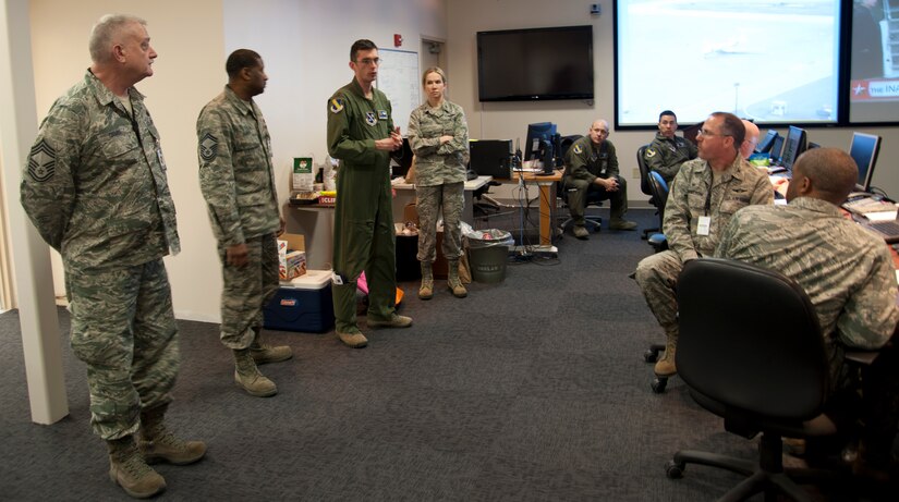 Maj. John Alsbrooks (third from left), 11th Wing’s crisis action team director, updates fellow team members at Joint Base Andrews, Md., Jan. 20, 2017, about the status of the Airmen participating in the 58th Presidential Inauguration parade and ceremony. The CAT comprised approximately 20 representatives from every major mission partner within JBA. (U.S. Air Force photo by Staff Sgt. Joe Yanik)