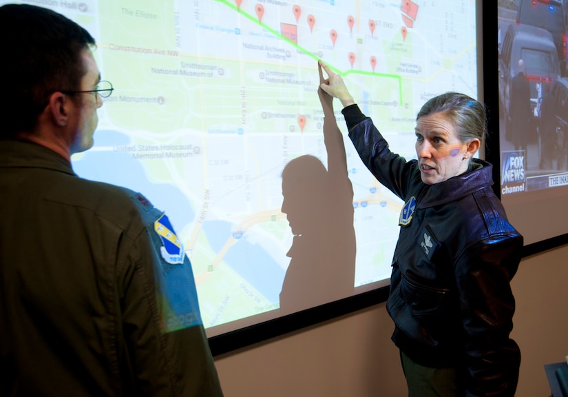 Col. Julie Grundahl (right), 11th Wing and Joint Base Andrews vice commander, discusses positions of Air Force personnel with Maj. John Alsbrooks, 11th Wing’s crisis action team director, at JBA, Md., Jan. 20, 2017. The CAT operated from JBA to monitor and coordinate Airmen movements and activities throughout multiple geographic areas in the District of Columbia during the 58th Presidential Inauguration parade and ceremony. (U.S. Air Force photo by Staff Sgt. Joe Yanik)