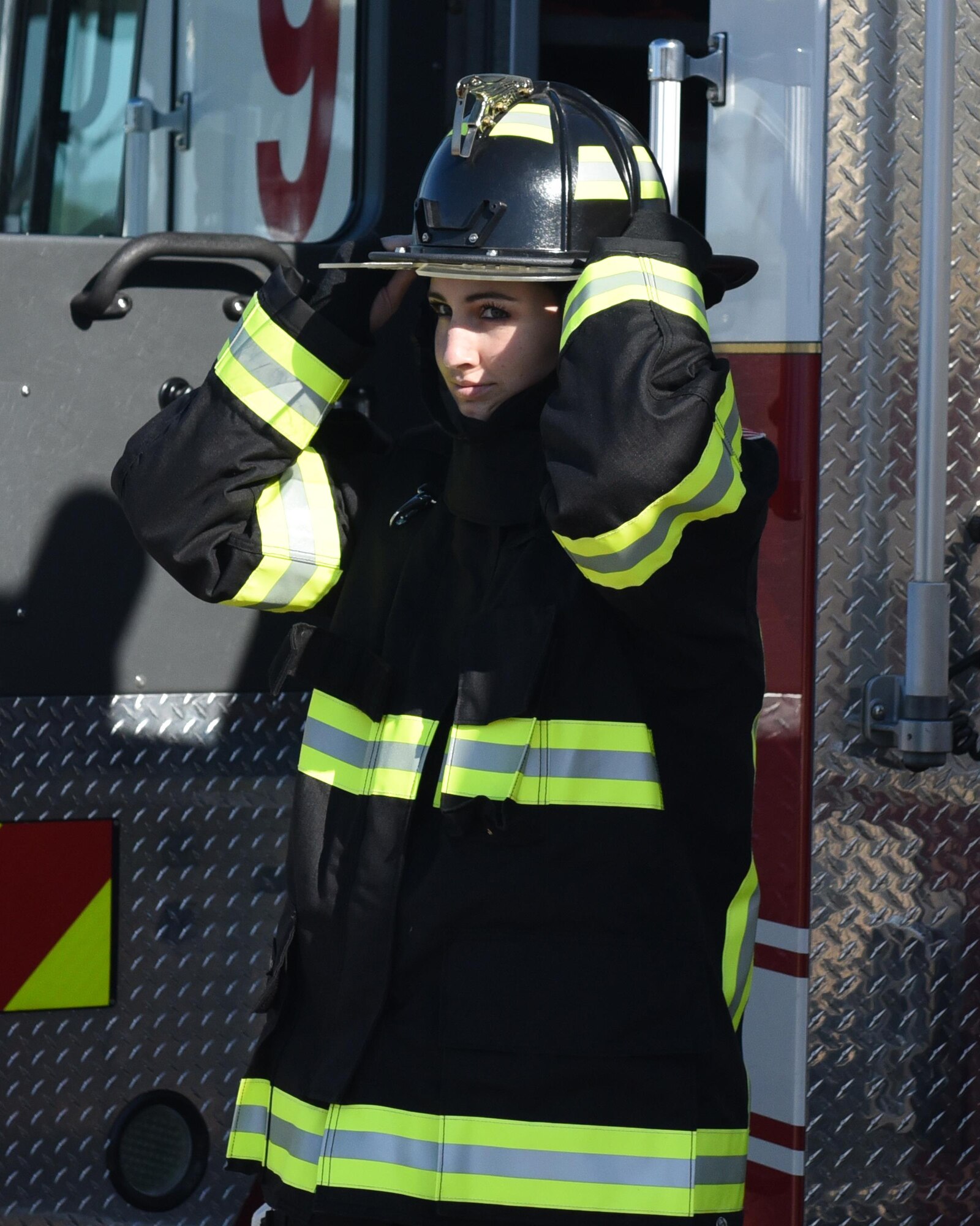 U.S. Air Force Airman 1st Class Casarah Pine, 325th Force Support Squadron food services specialist, dresses in fire protection gear during her Air Force Specialty immersion at Tyndall Air Force Base, Fla., Dec. 7, 2016. The program is used to show Airmen that are interested in cross training, what their potential new job would be like. (U.S. Air Force photo by Airman 1st Class Cody R. Miller/Released)
