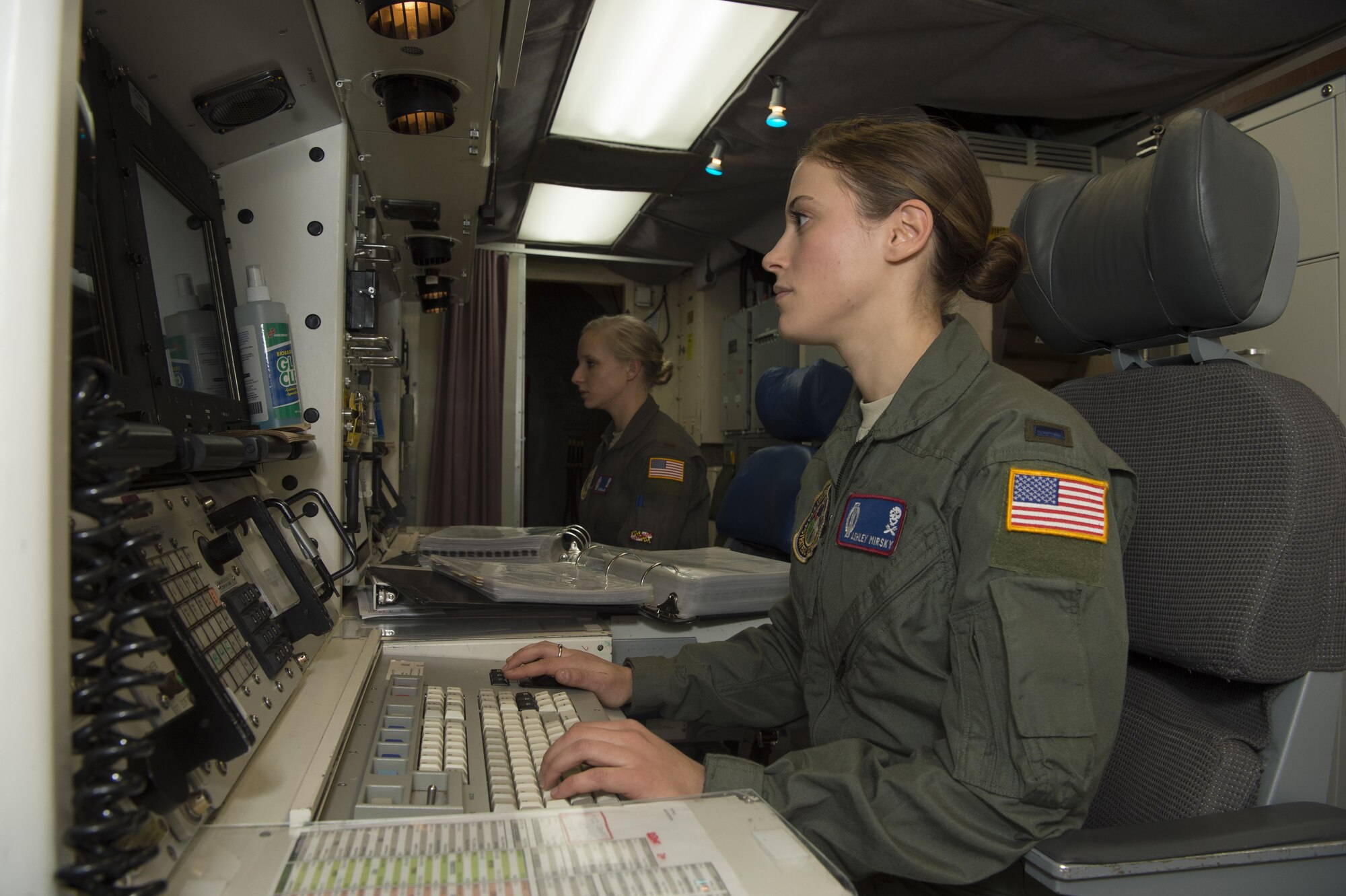 First Lt. Ashley Mirsky, 319th Missile Squadron missile combat crew commander, and 2nd Lt. Marie Blair, 319th MS deputy missile combat crew commander, check their monitors in a launch control center in the 90th Missile Wing missile complex, Dec. 19, 2016. The crew ensures they execute the mission safely, securely and effectively by holding each other accountable on job knowledge and striving to always improve. (U.S. Air Force photo by 1st Lt. Veronica Perez)