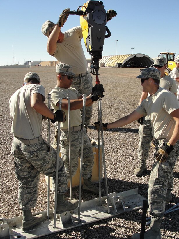 635th Supply Chain Operations Wing Airmen, assigned to the 635th Materiel Maintenance Group, install foundation rods to erect an 8,000 square-foot dome shelter. (Air Force photo)