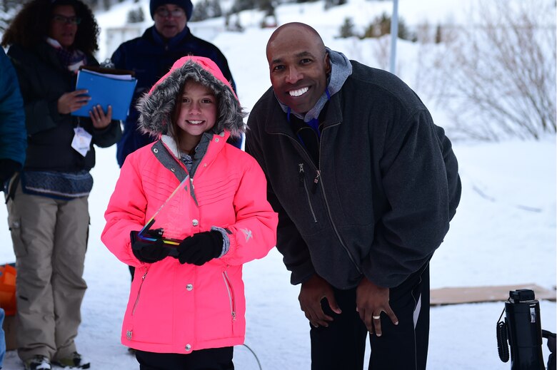 Jordan, a Team Buckley youth, and Col. Troy Dunn, 10th Air Base Wing Commander at U.S. Air Force Academy in Colorado Springs, Colo., pose for a photo Jan 21, 2017, at Copper Mountain, Colo. Jordan competed in the cardboard derby race and won the fastest down the hill award. (U.S. Air Force photo by Airman Jacob Deatherage/Released)